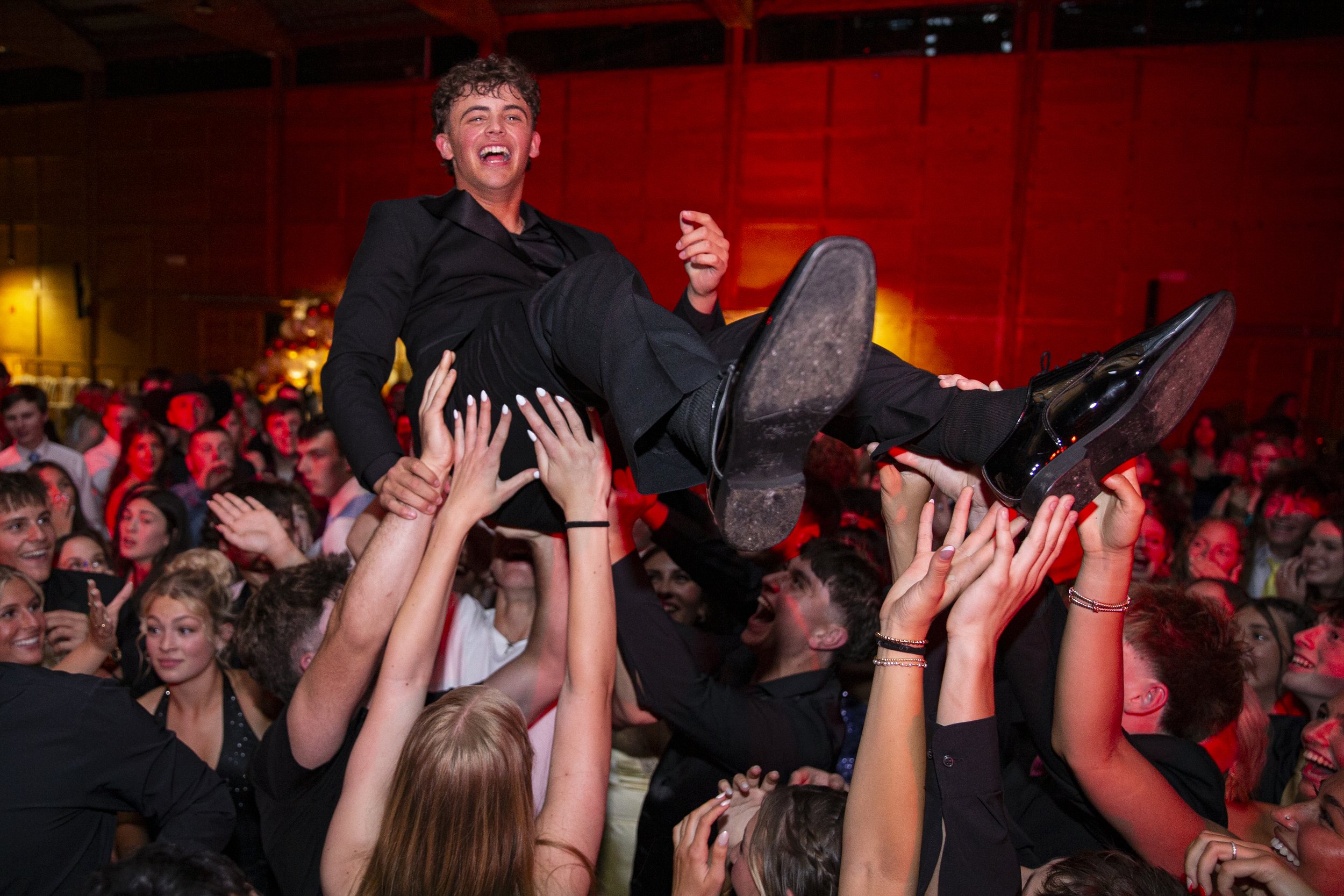 Hudson Waples gets carried by his peers during Silverton's prom at the Oregon Garden on Saturday, May 3, 2025, in Silverton, Ore.