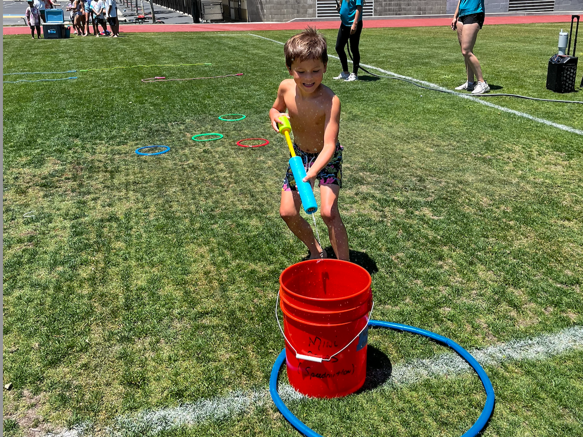 Overtime Sports Camp Camper playing water games in Los Gatos, California. Bay Area Summer Sports Camp.