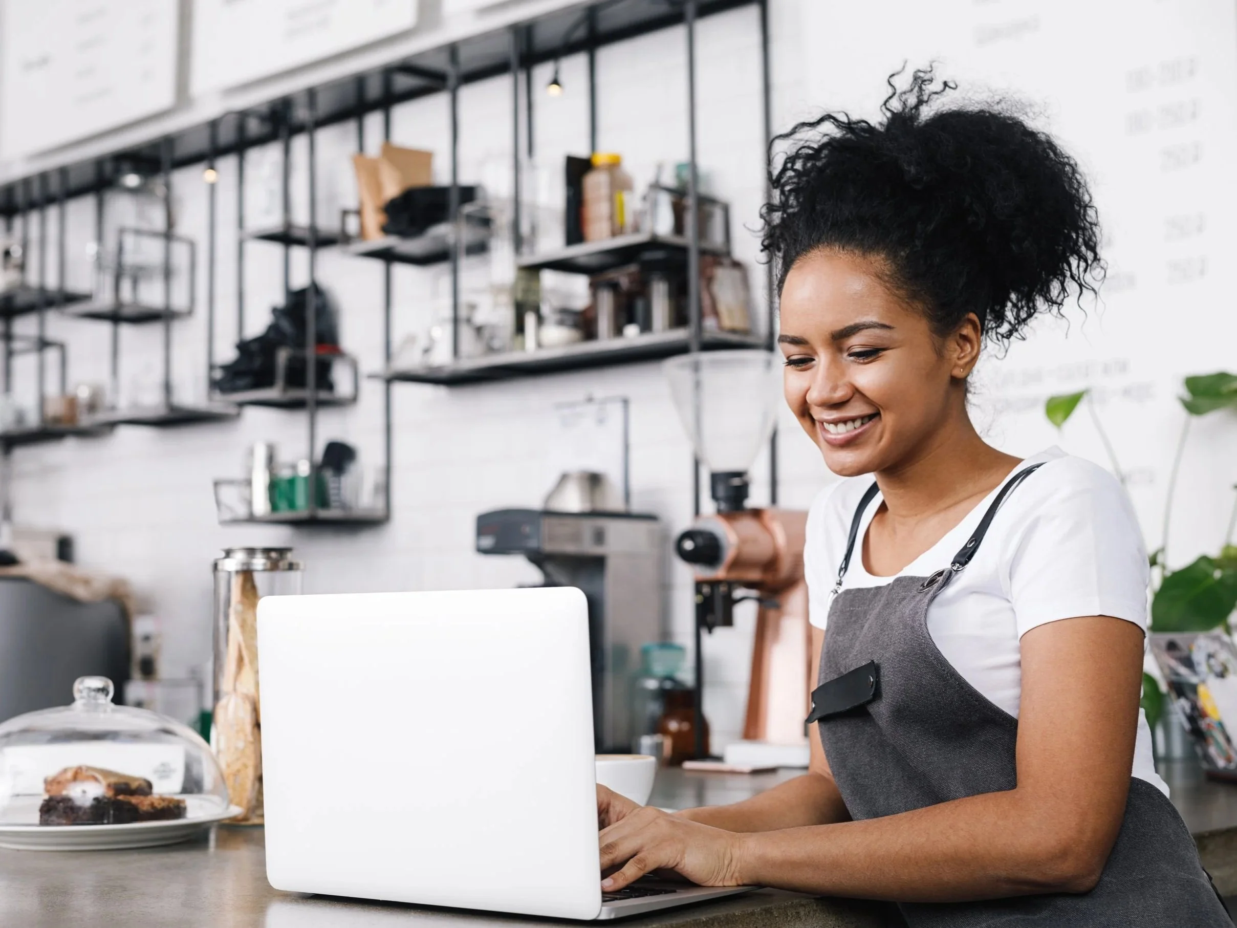 woman smiling looking at a laptop