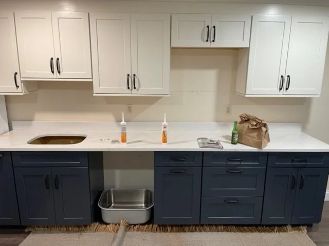 White Upper Cabinets With Dark Navy Lower Cabinets Kitchen Remodel by Malcolm Contracting Services LLC project photo