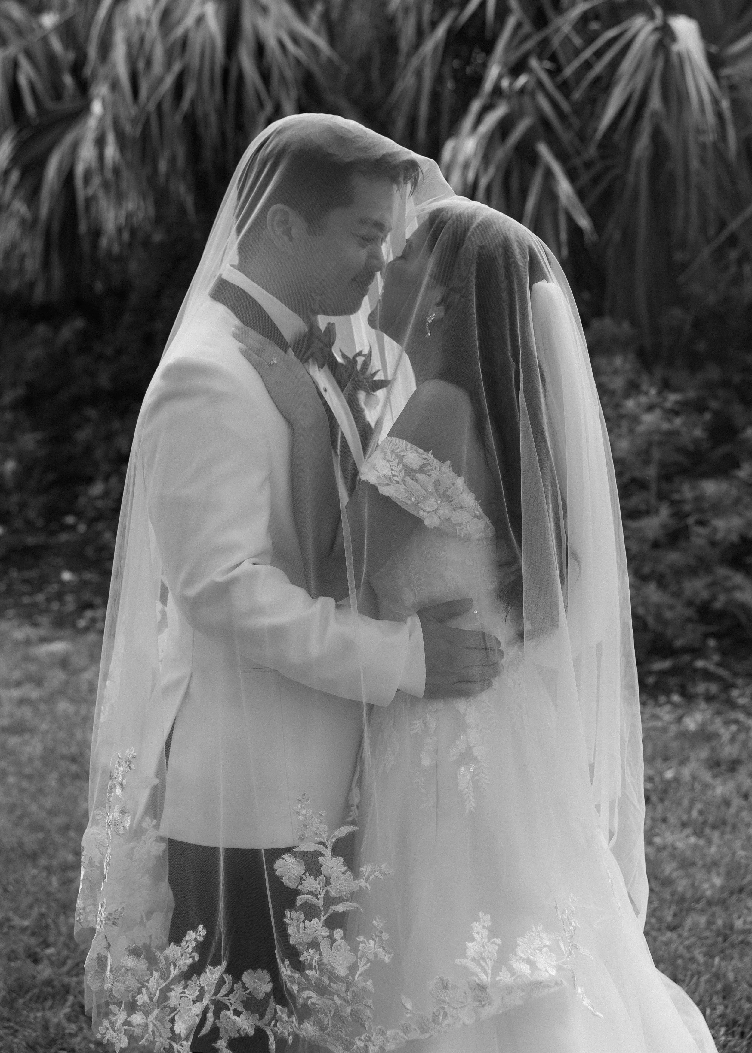 bride and groom under veil