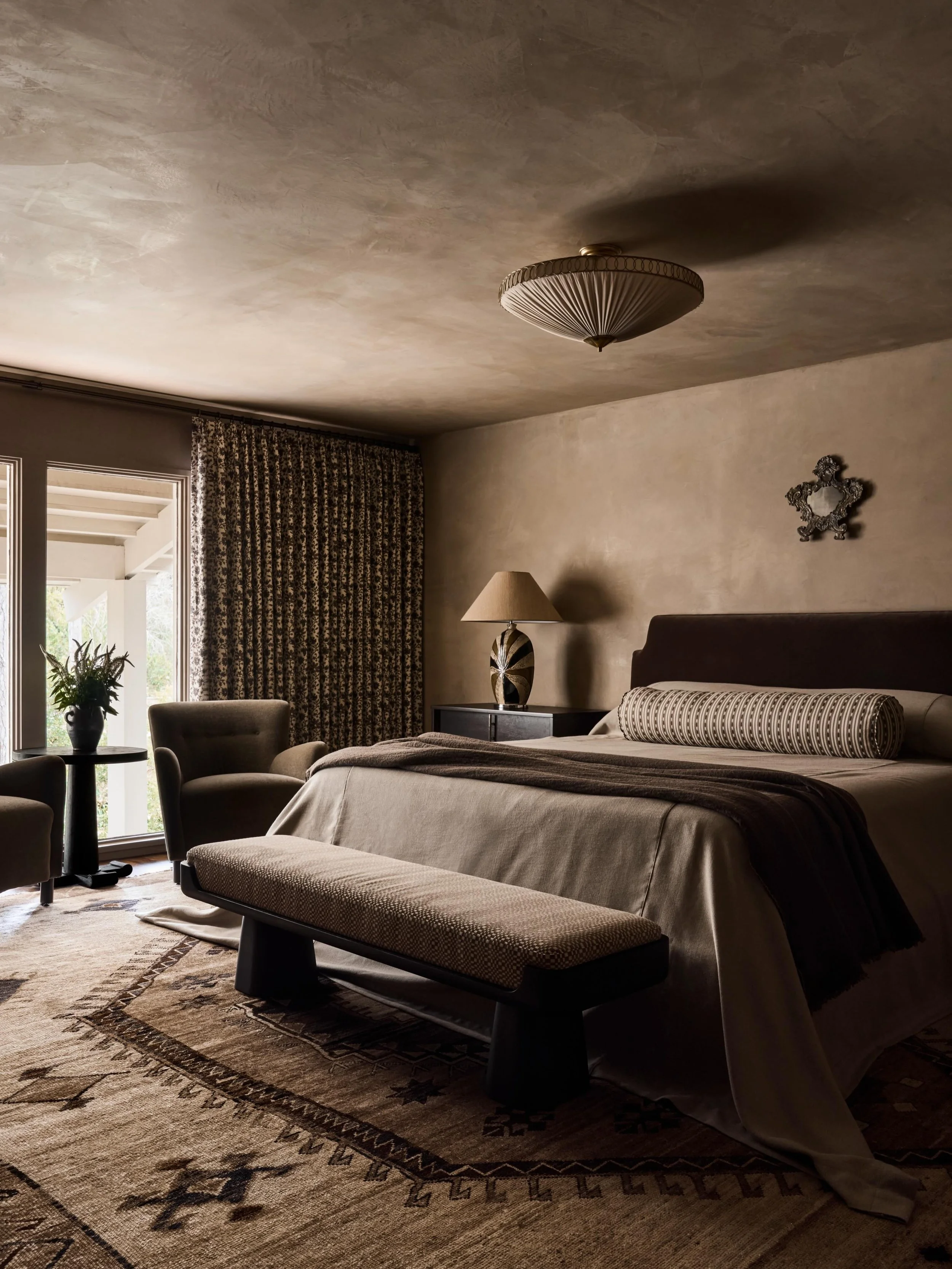 Before and after at our Tanglewood project. Our clients wanted their new primary suite to feel warm, layered, and moody. By embracing the lower ceilings and wrapping the room in an earthy gray plaster finish, we created a cozy &amp; intimate retreat.