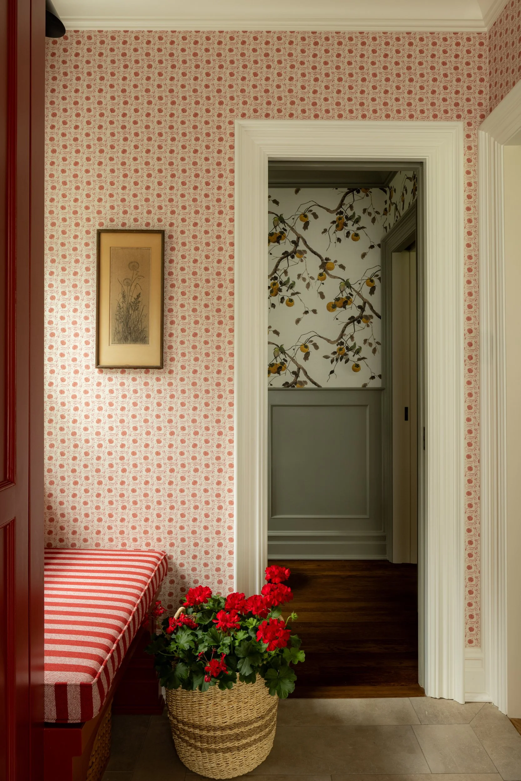 Red floral wallpaper hallway with grey door by Raquel Langworthy