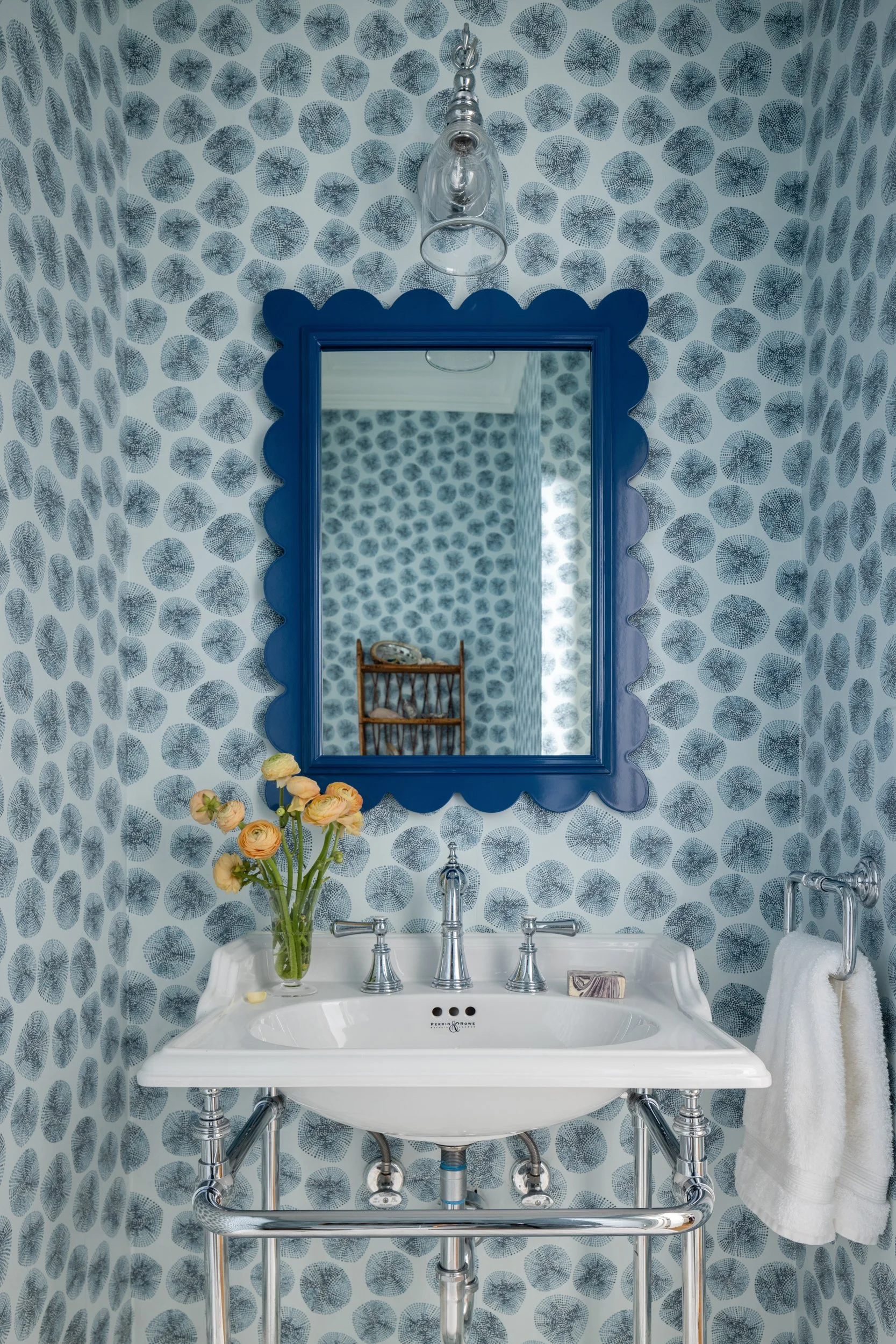 Blue patterned wallpaper bathroom with pedestal sink by Raquel Langworthy