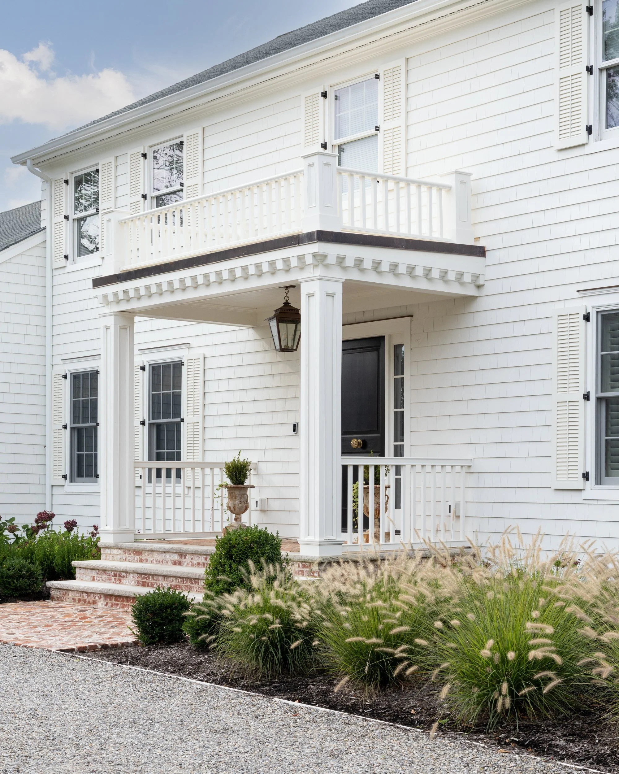 White colonial house exterior by Raquel Langworthy