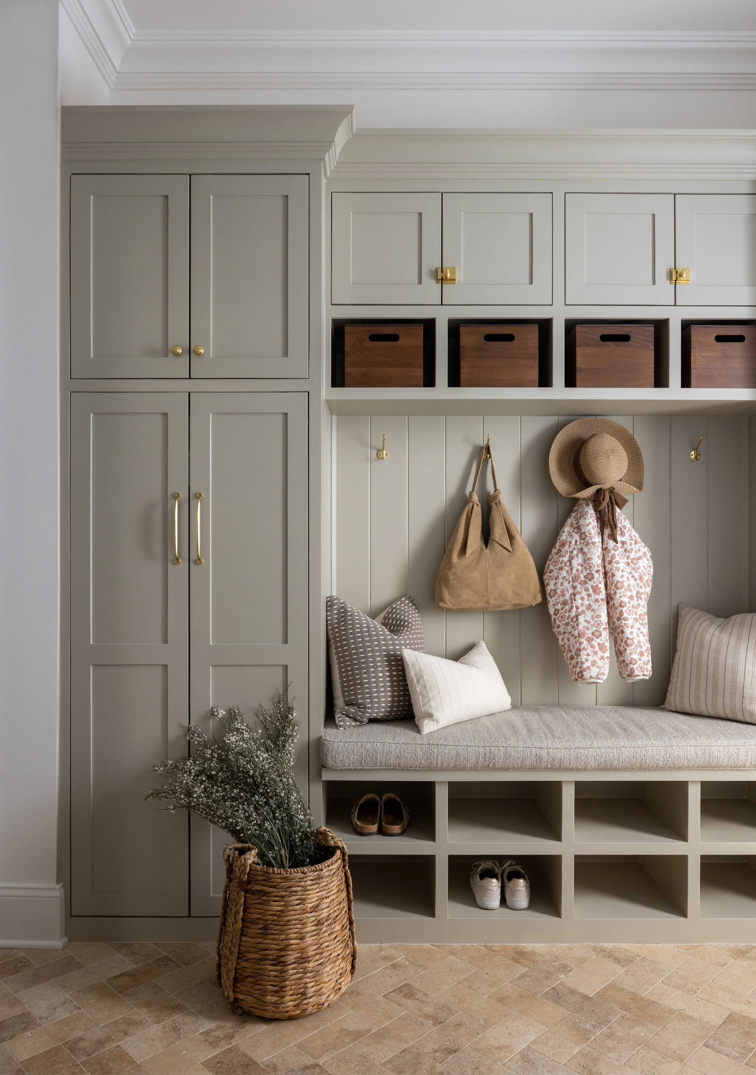 Grey mudroom with built-in lockers and bench by Raquel Langworthy