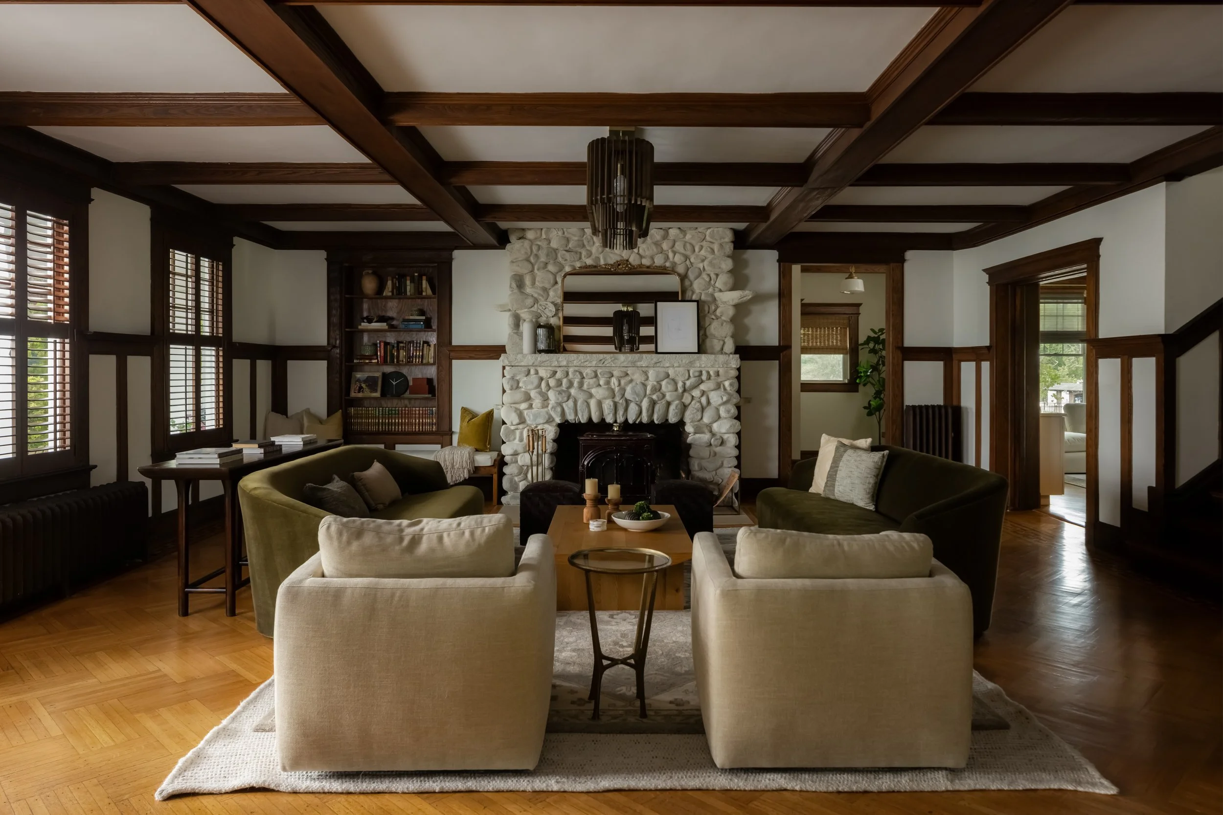Cozy living room with fireplace and beamed ceiling by Raquel Langworthy