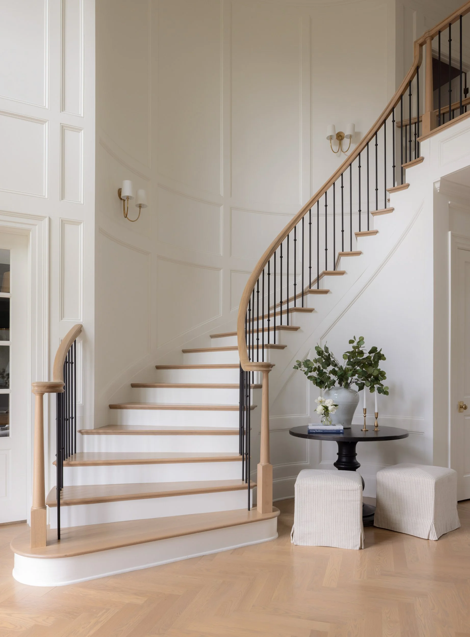 White staircase with black railing by Raquel Langworthy