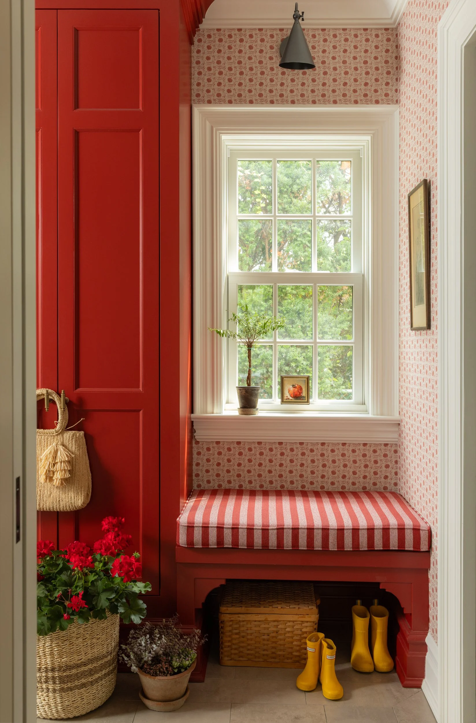 Red door mudroom bench with brick wall by Raquel Langworthy