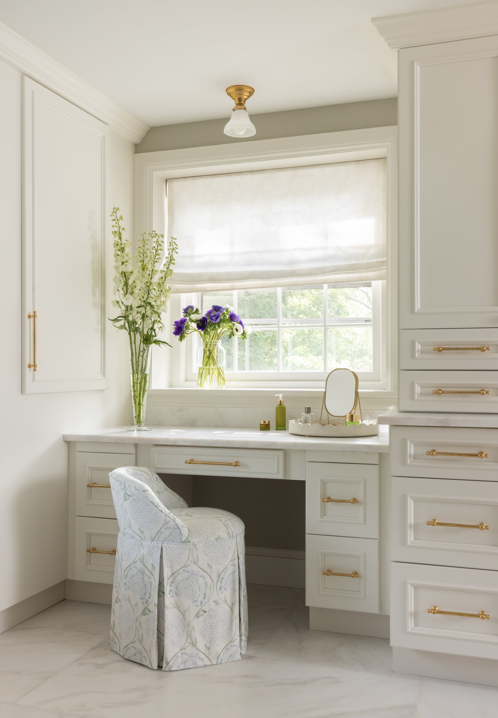 White built-in vanity desk with gold pendant light by Raquel Langworthy