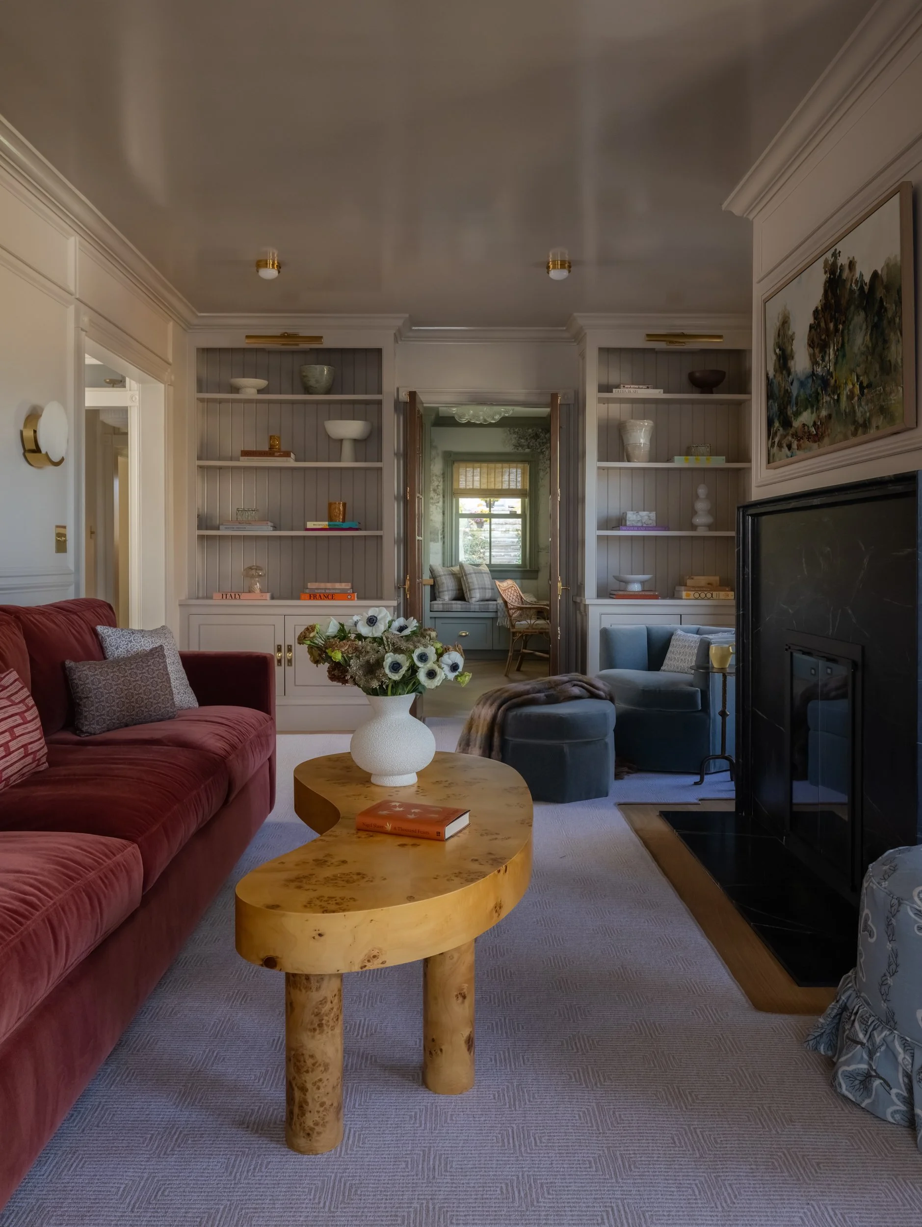 Living room with round wood coffee table photographed by Raquel Langworthy