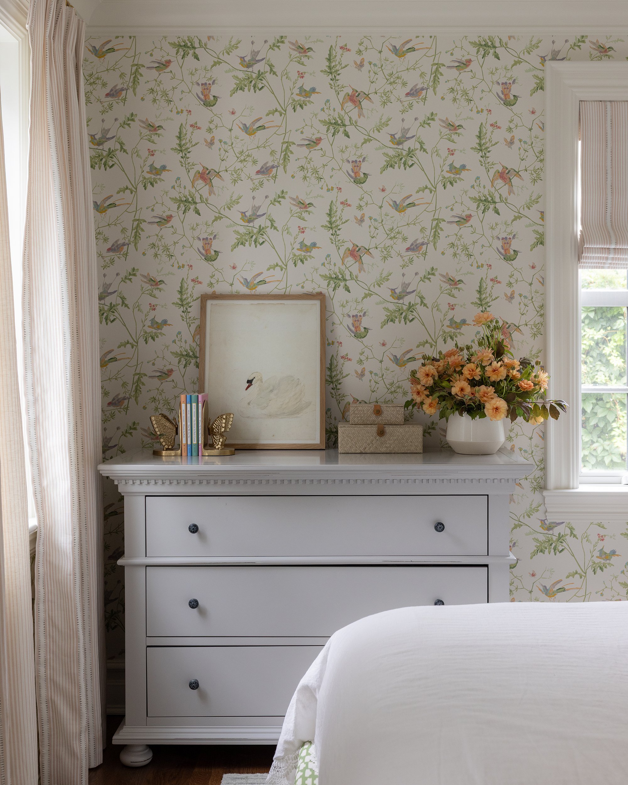 Floral wallpaper bedroom with white dresser by Raquel Langworthy