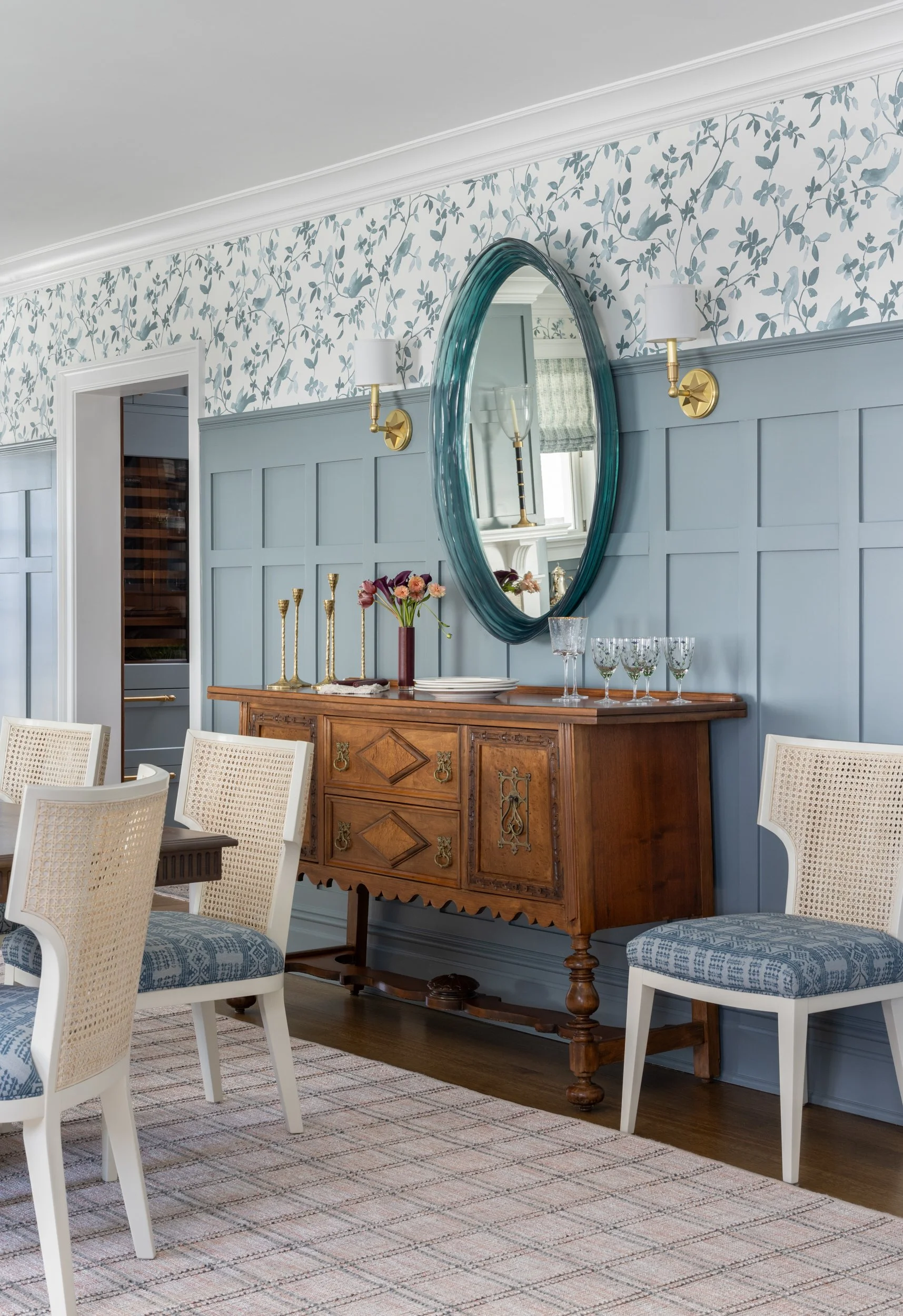 Blue bedroom with floral wallpaper and antique dresser by Raquel Langworthy