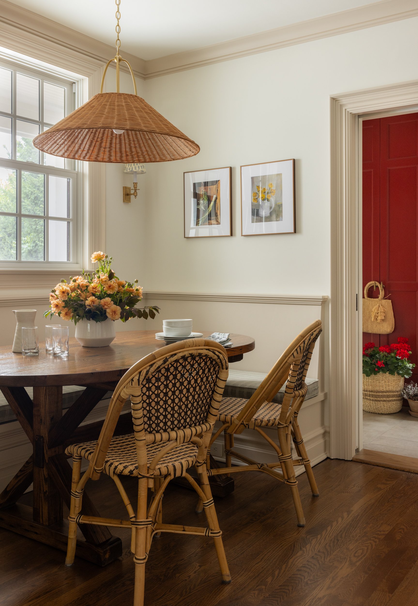 Cozy reading nook with rattan pendant and framed art by Raquel Langworthy