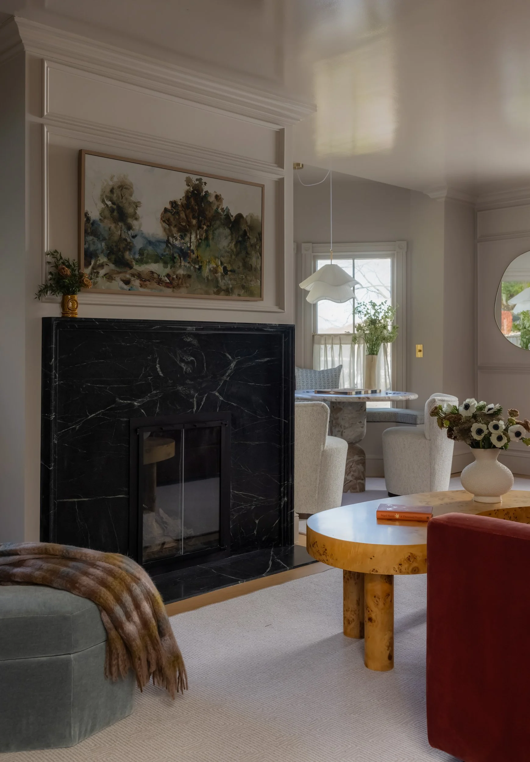 Living room with stone fireplace by Raquel Langworthy