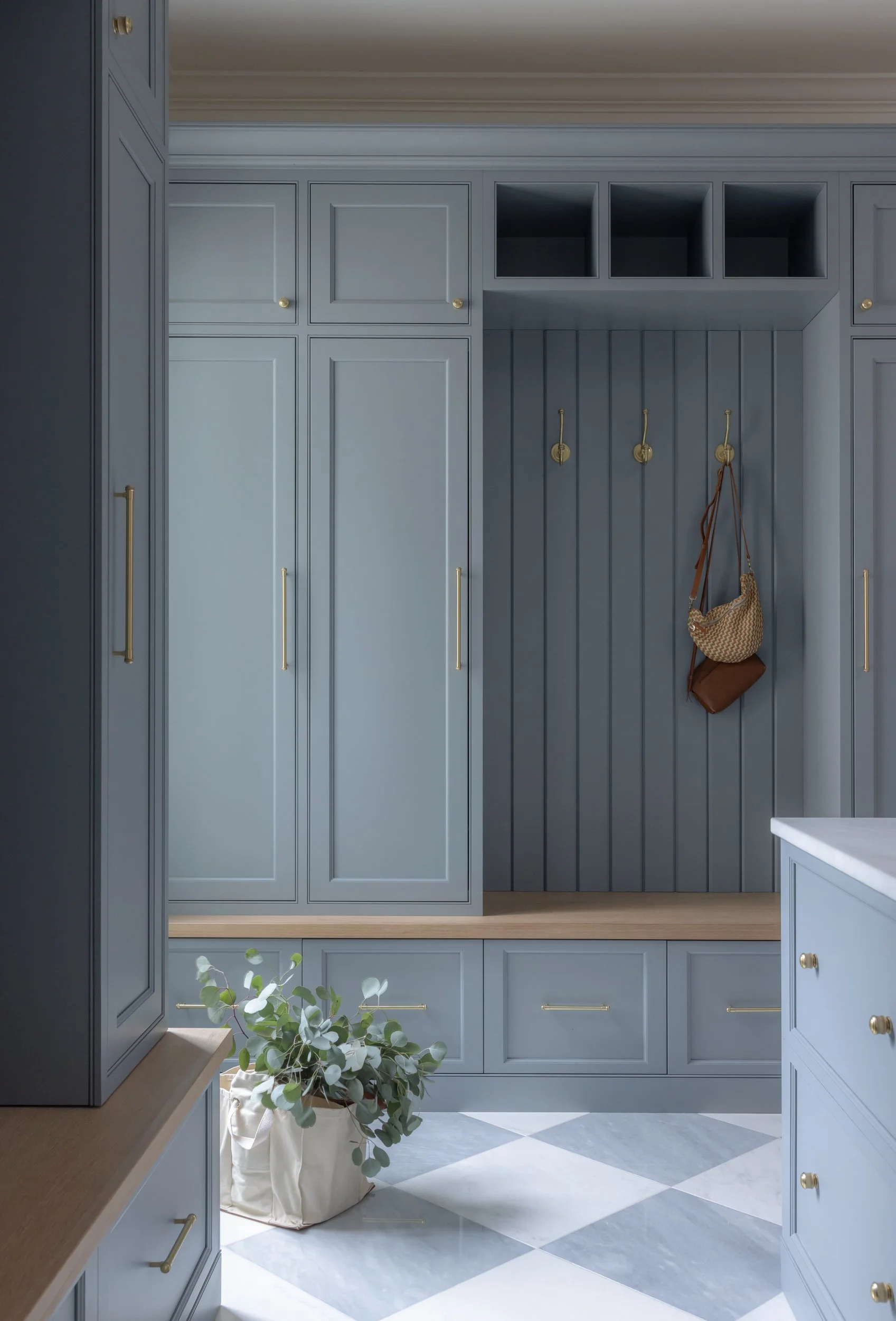 Blue grey mudroom with built-in cabinets by Raquel Langworthy