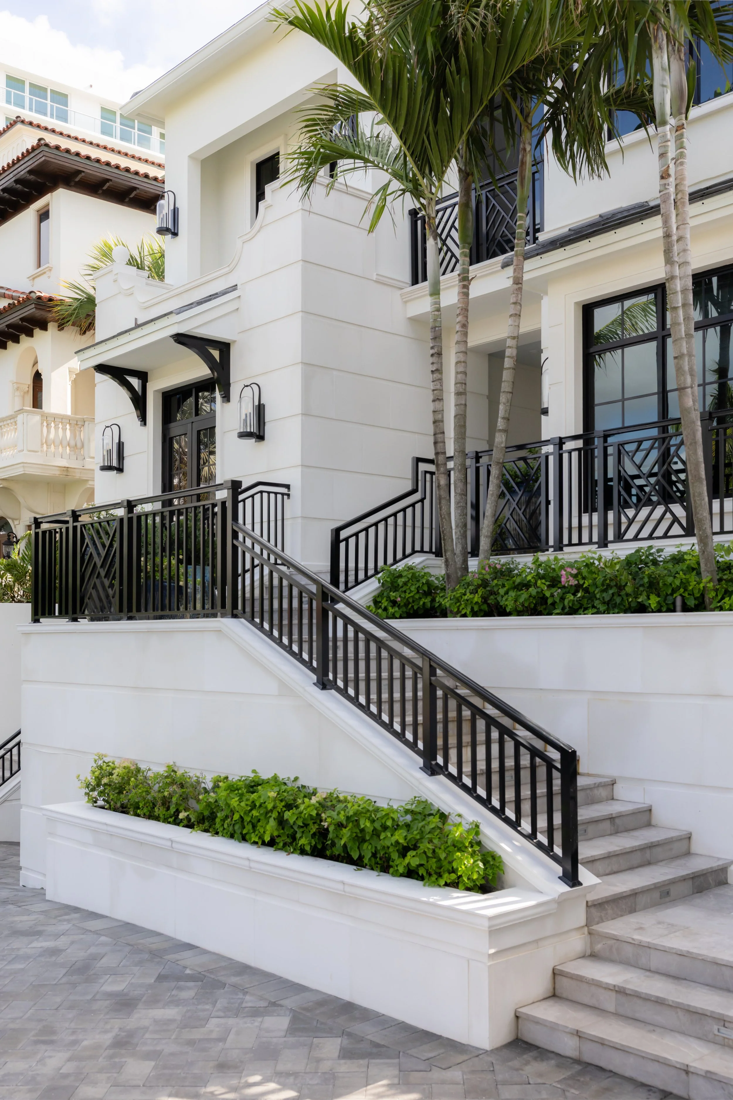 Luxury home exterior with balcony and landscaping by Raquel Langworthy