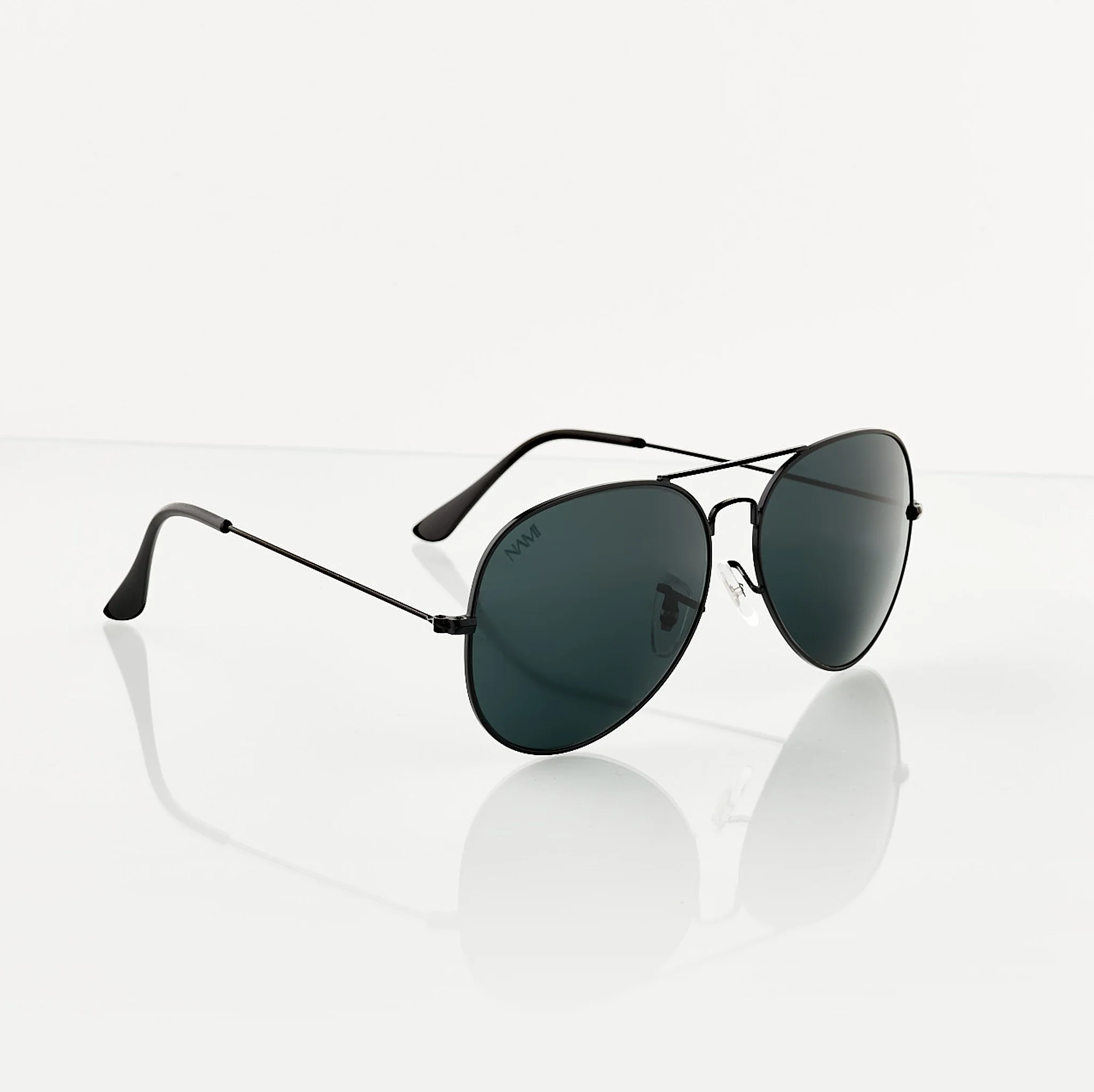 Black aviator sunglasses with dark lenses on a white reflective surface.