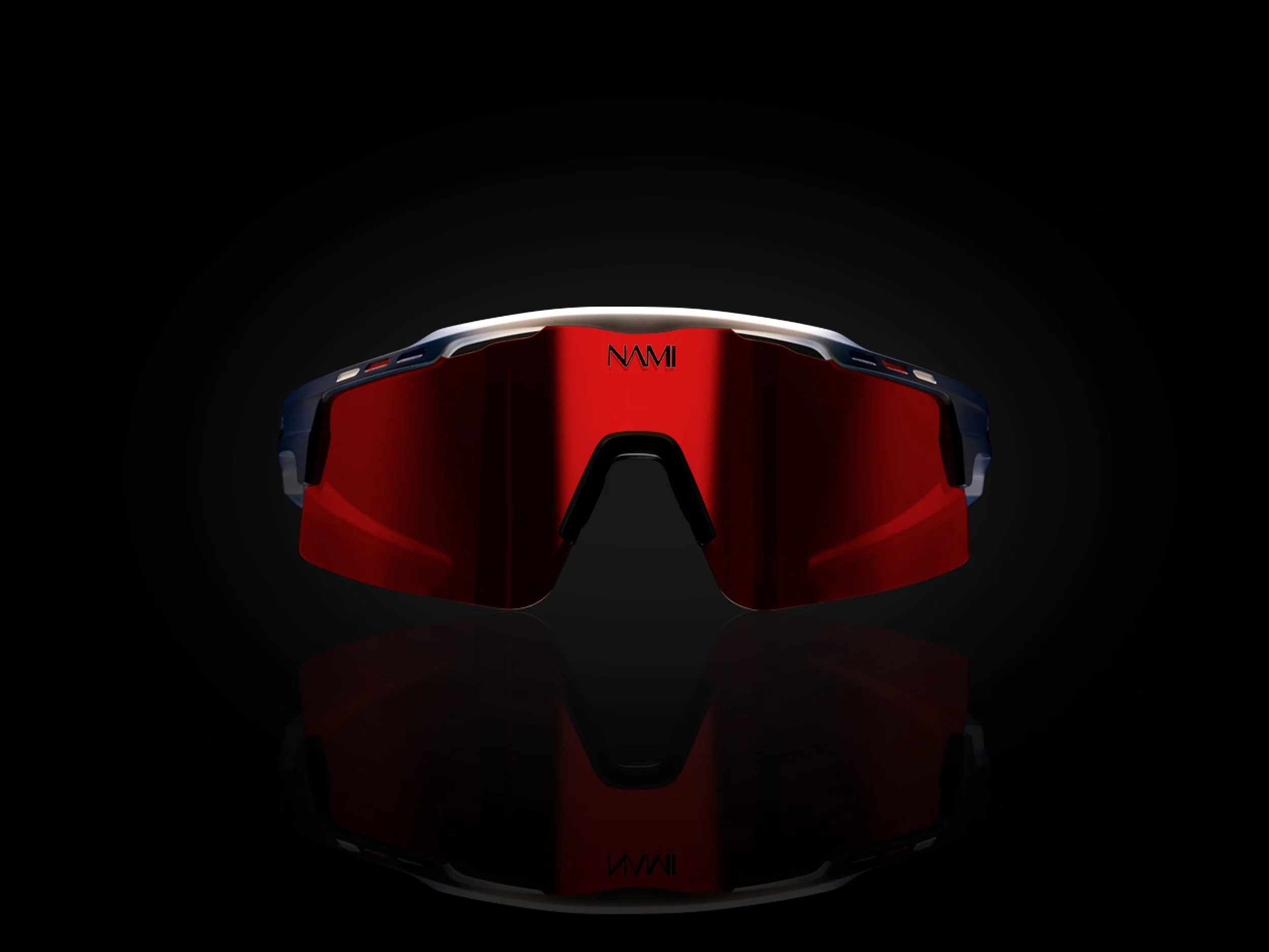 Close-up of a pair of sports sunglasses with red lenses and a white and black frame, set against a black background with a reflection below.