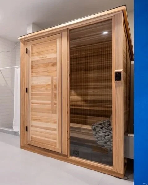 Wooden sauna with glass door and digital control panel inside