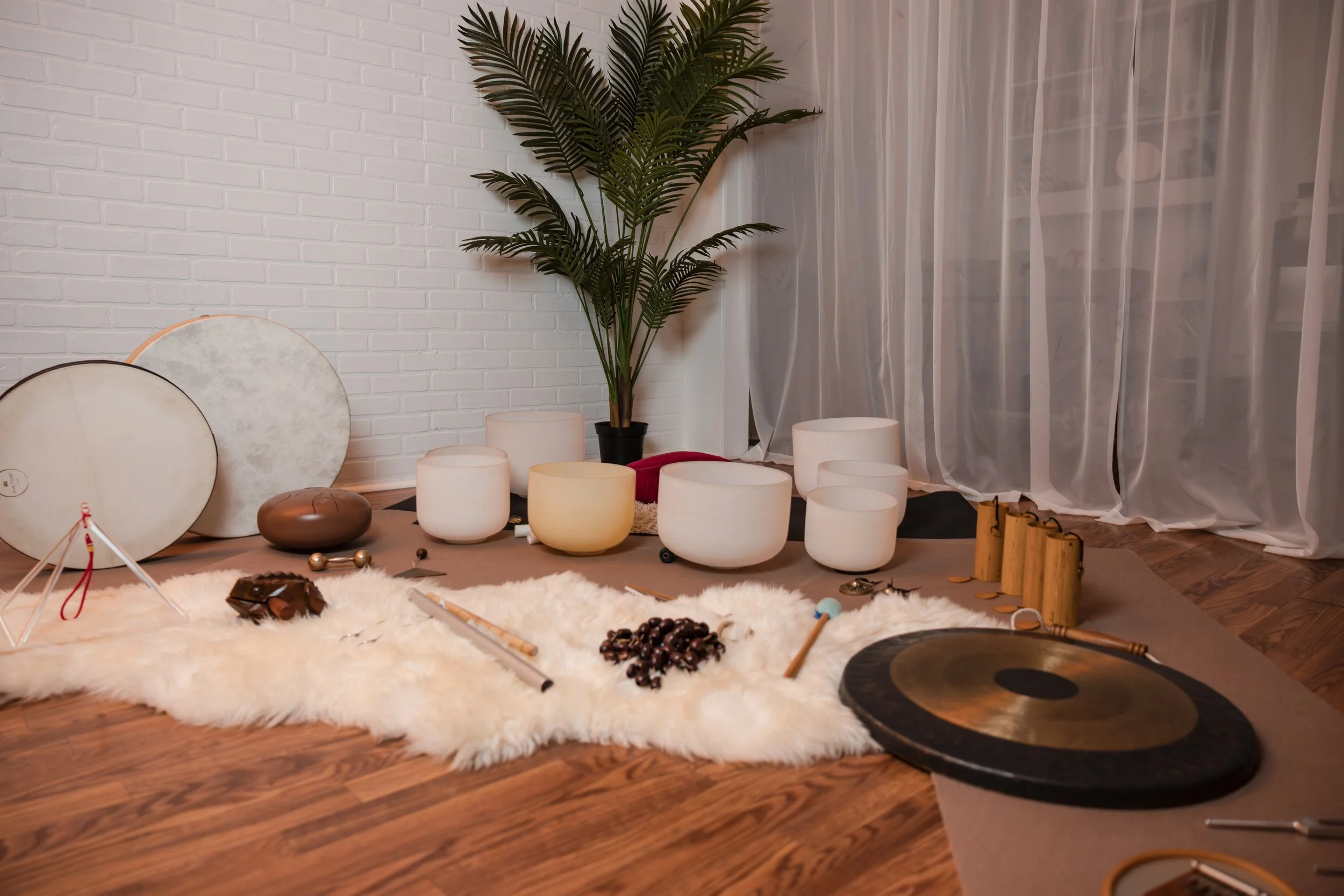 Crystal singing bowls and sound bath instruments arranged for a guided relaxation session.