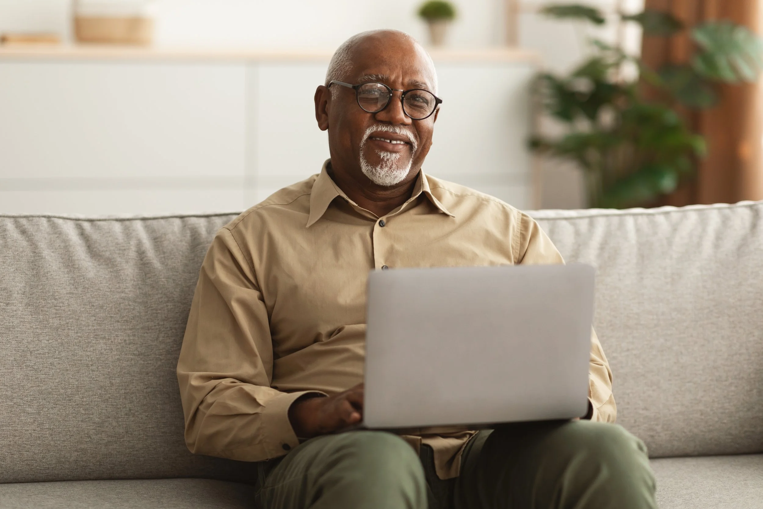 Person using a laptop at home while reviewing information related to the Columbus housing market.