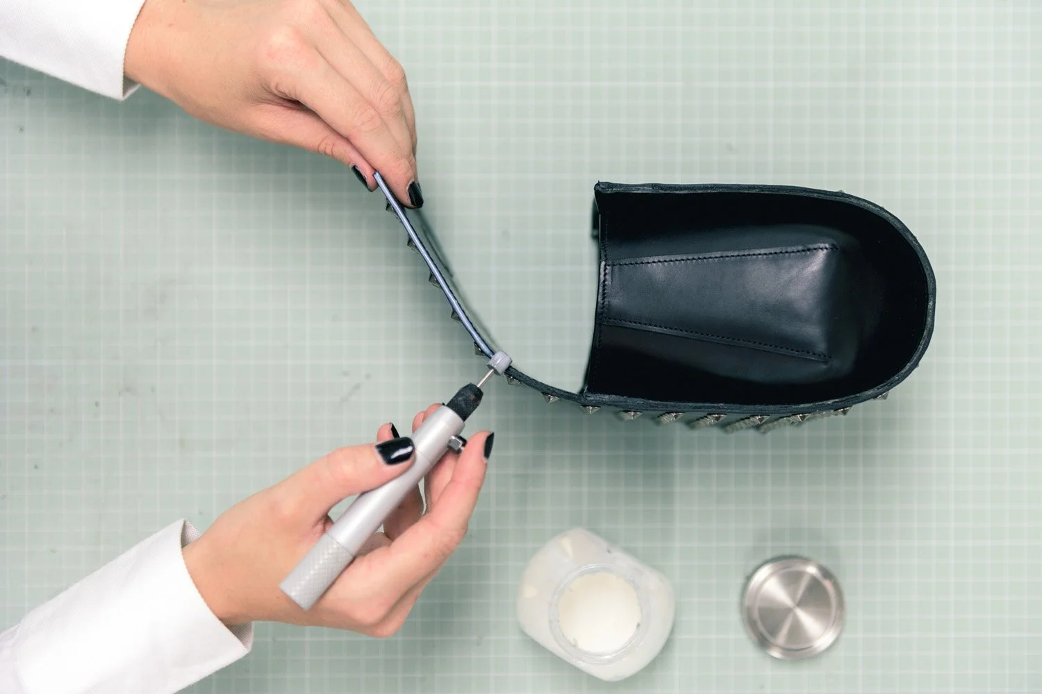 Artisan Edge Painting the Flap of a Leather Bag