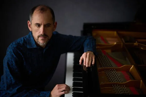 Pianist Danny Driver with his hands on the piano keyboard