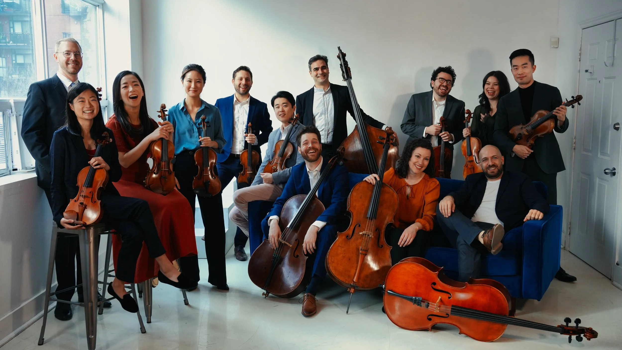 Canadian Chamber Orchestra relaxed headshot with instruments and members smiling