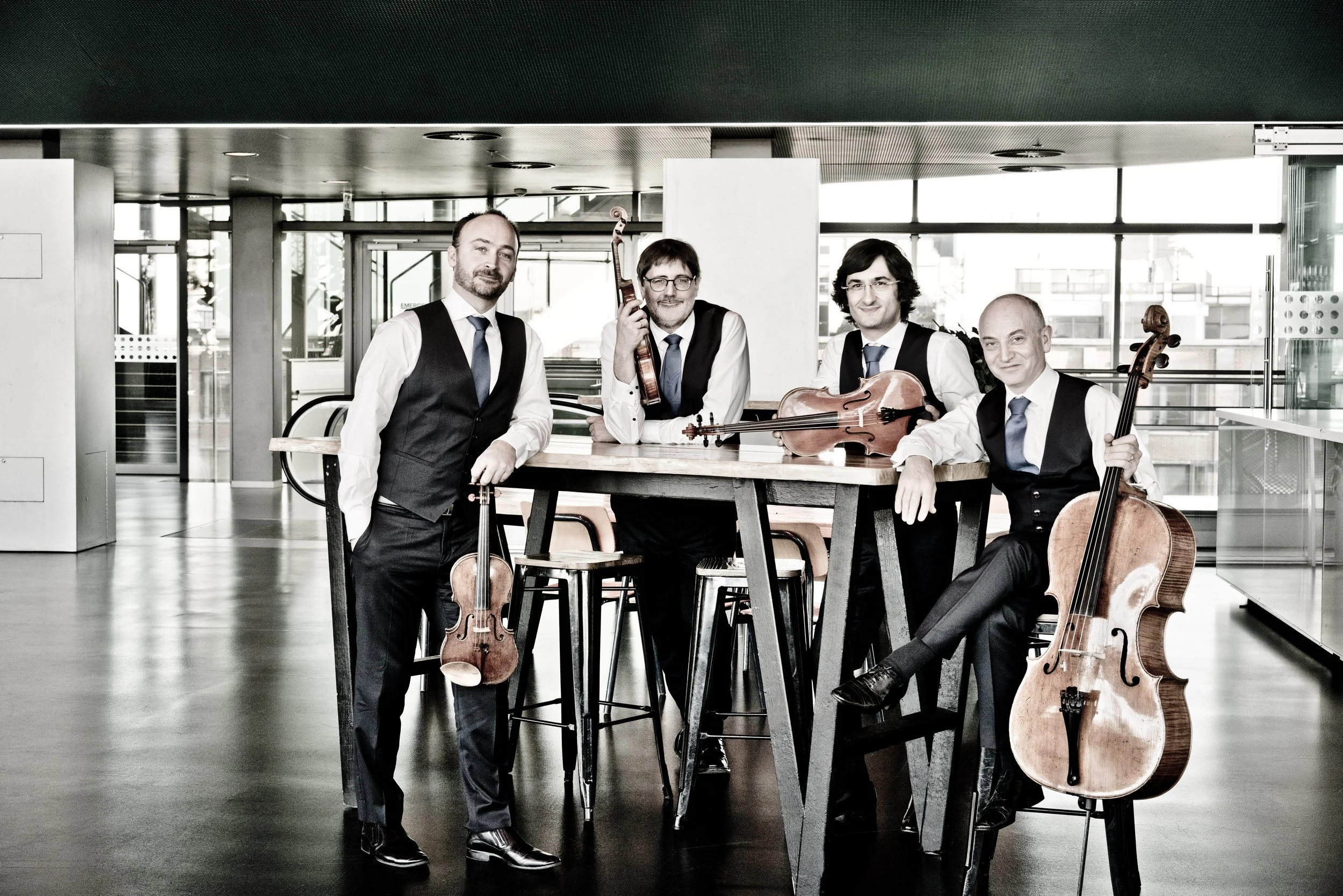 Quatuor Danel Headshot with their instruments