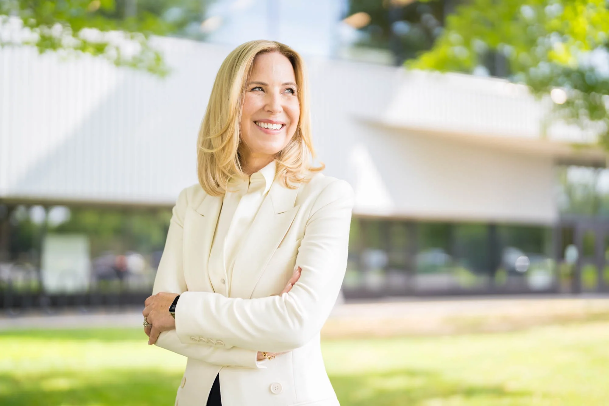 Professional executive portrait of a CEO, a woman in white suit.