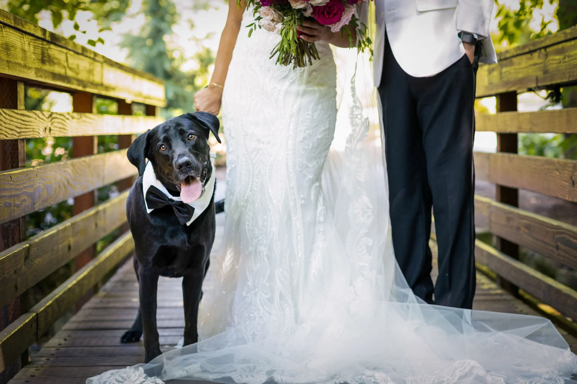 Bride and groom with dog at Abernethy Center garden wedding.