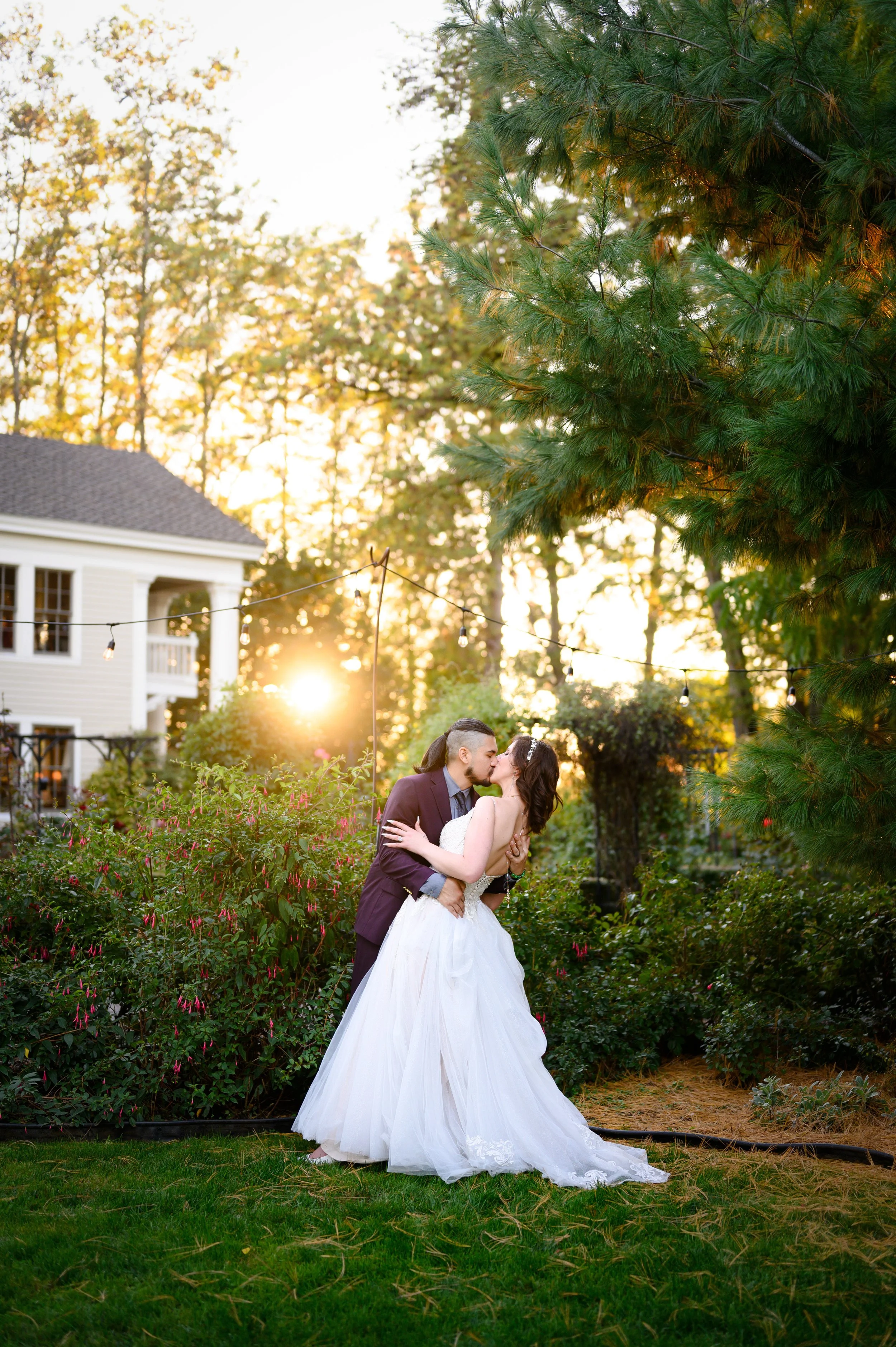 Wedding photo of bride and groom at golden hour at Ainsworth House and Gardens