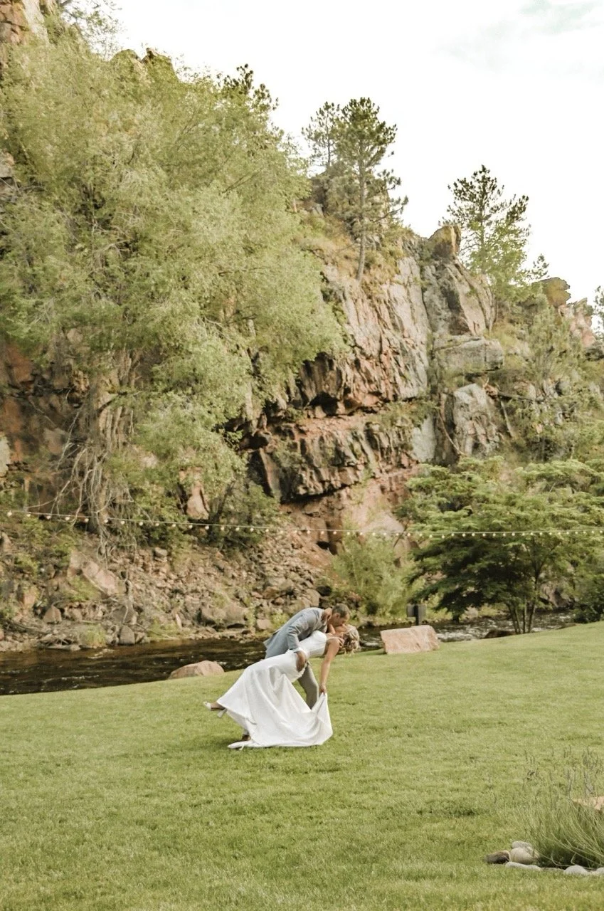 A bride and groom enjoying a moment by the river