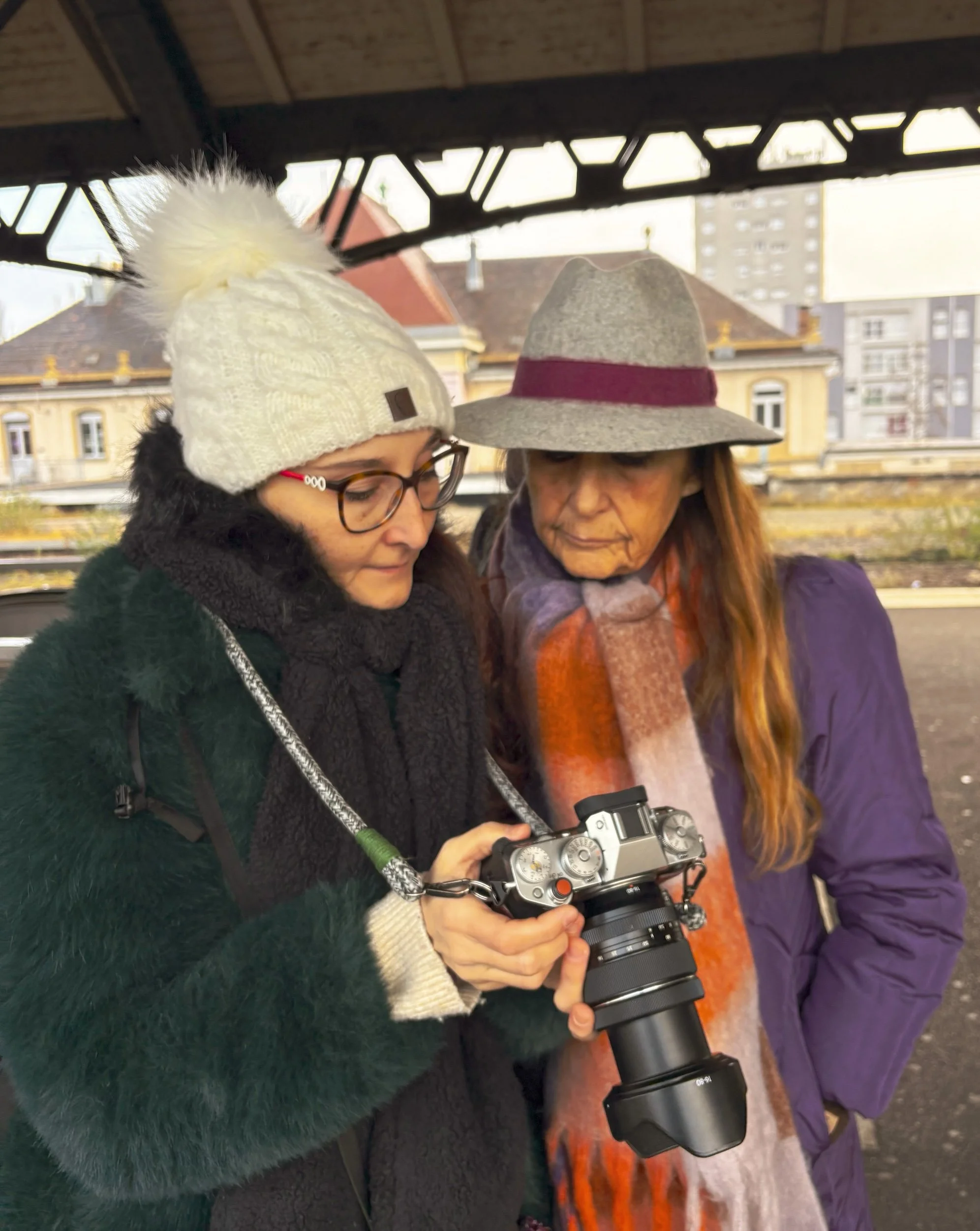 Street portrait of Very and her mom looking at a photo in the camera.