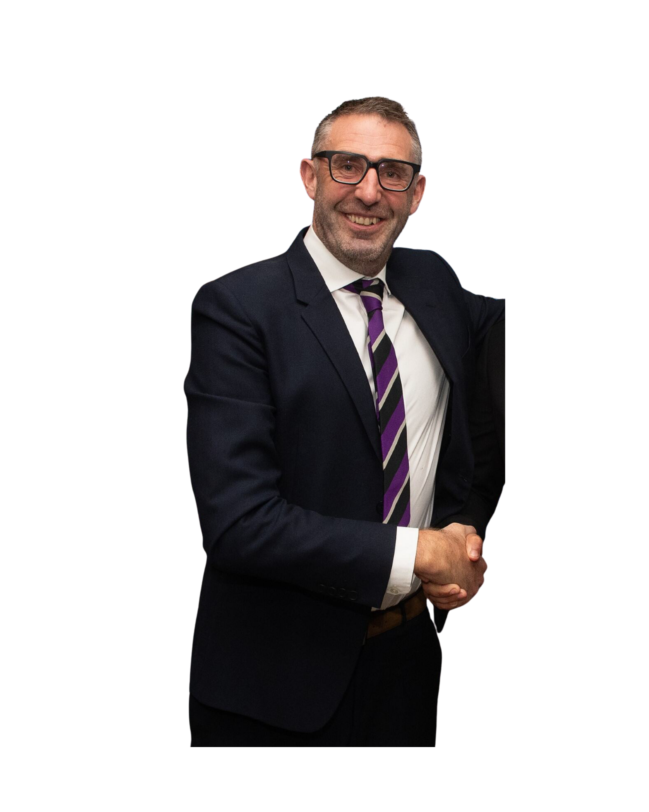 A man in a dark suit, white shirt, and purple-striped tie is smiling and shaking hands in front of a black background.