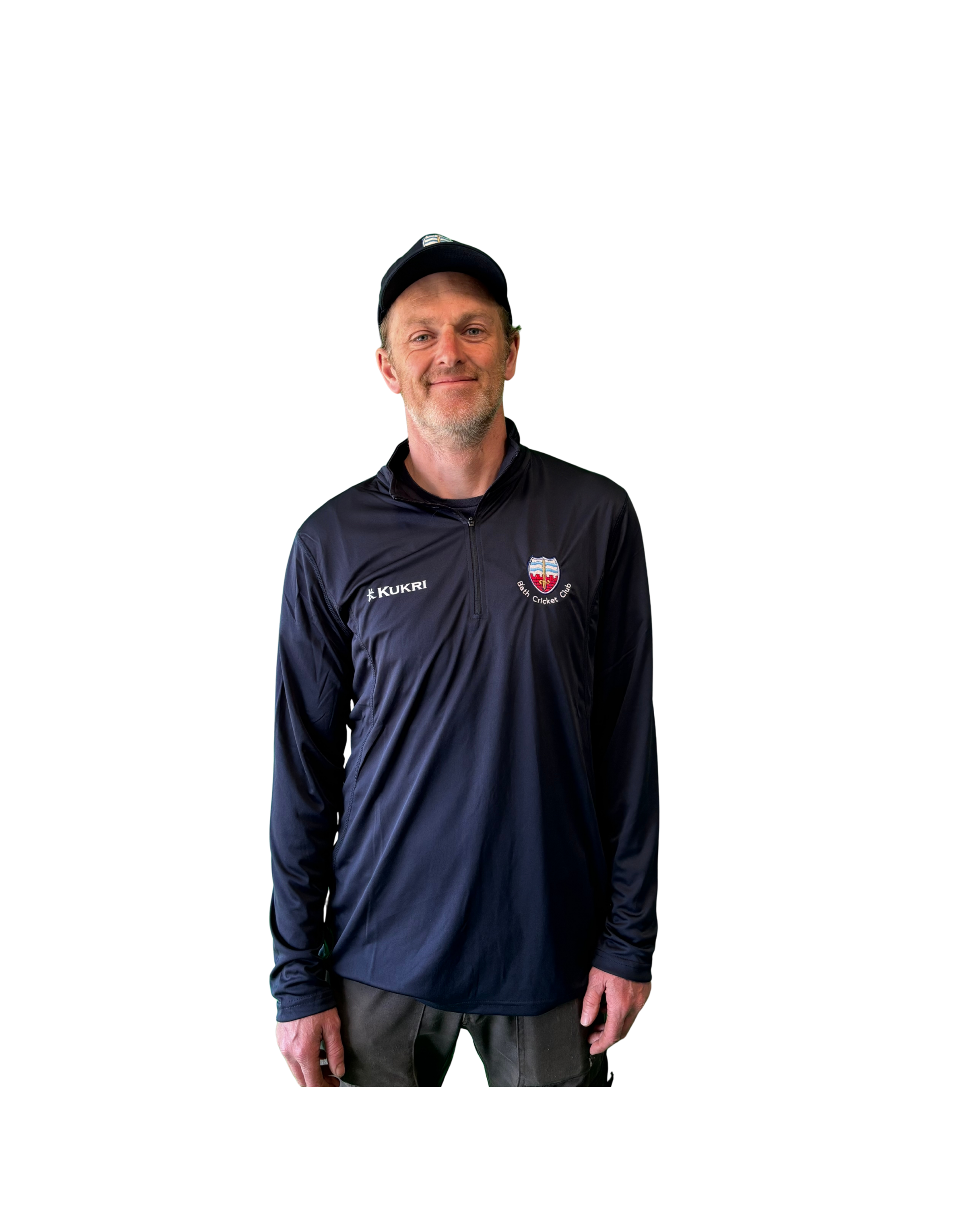 A middle-aged man with a beard wearing a black cap and athletic jacket with a logo of Bath Cricket Club stands against a black background.