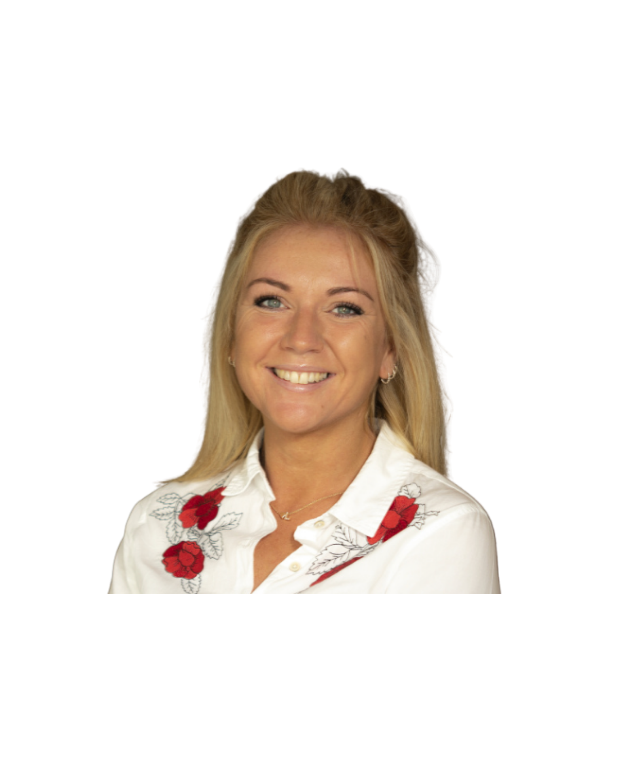 A woman with blonde hair, blue eyes, and earrings smiling, wearing a white blouse with red flower embroidery.
