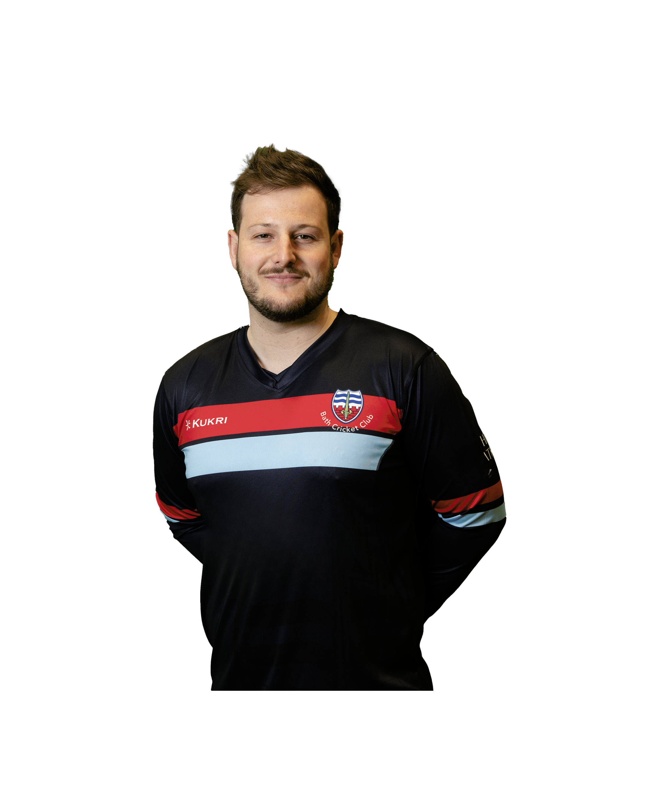 Portrait of a man with brown hair and a beard, smiling, wearing a black sports jersey with red, white, and blue horizontal stripes and a logo that reads Bath Cricket Club.