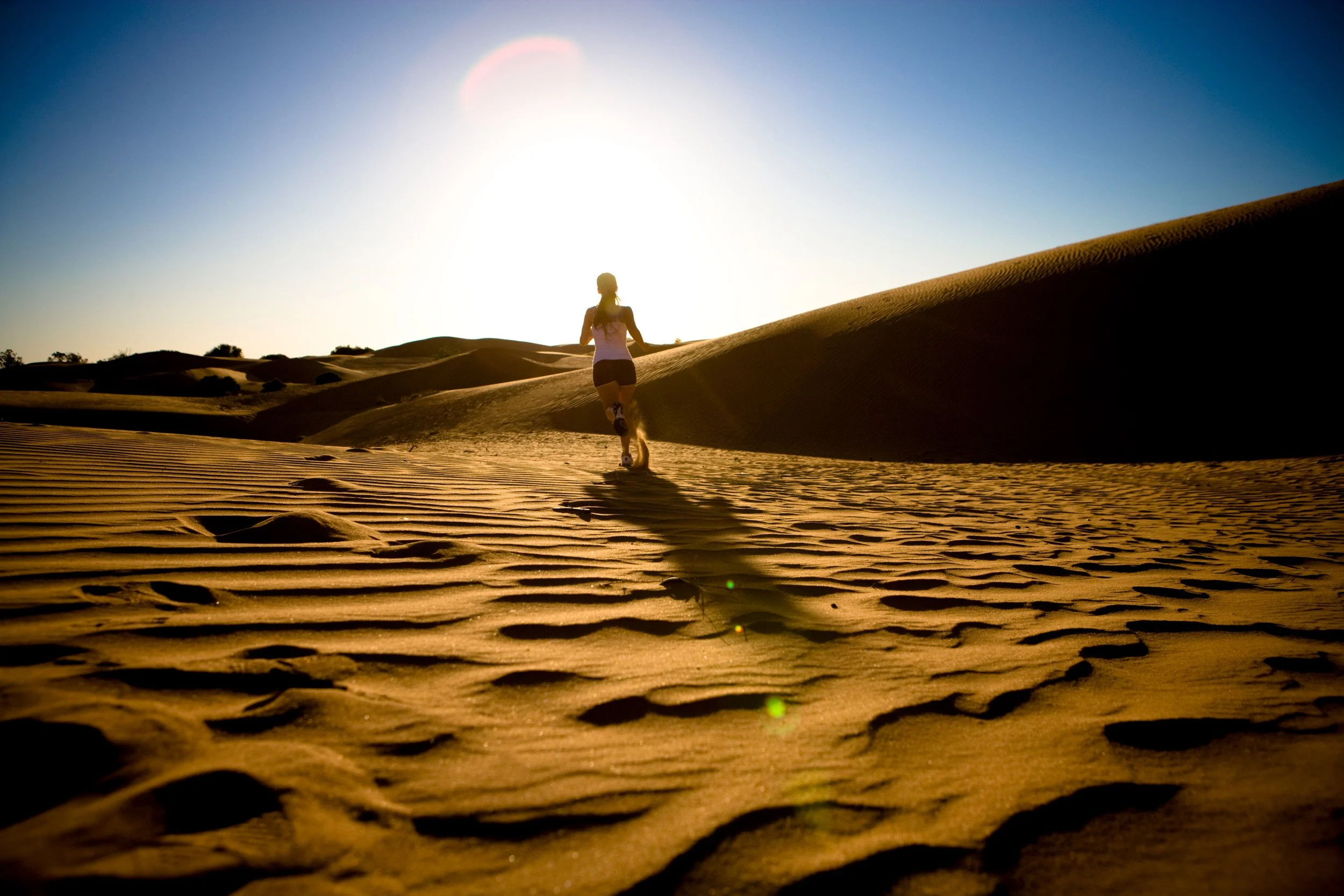 woman running in sanddunes