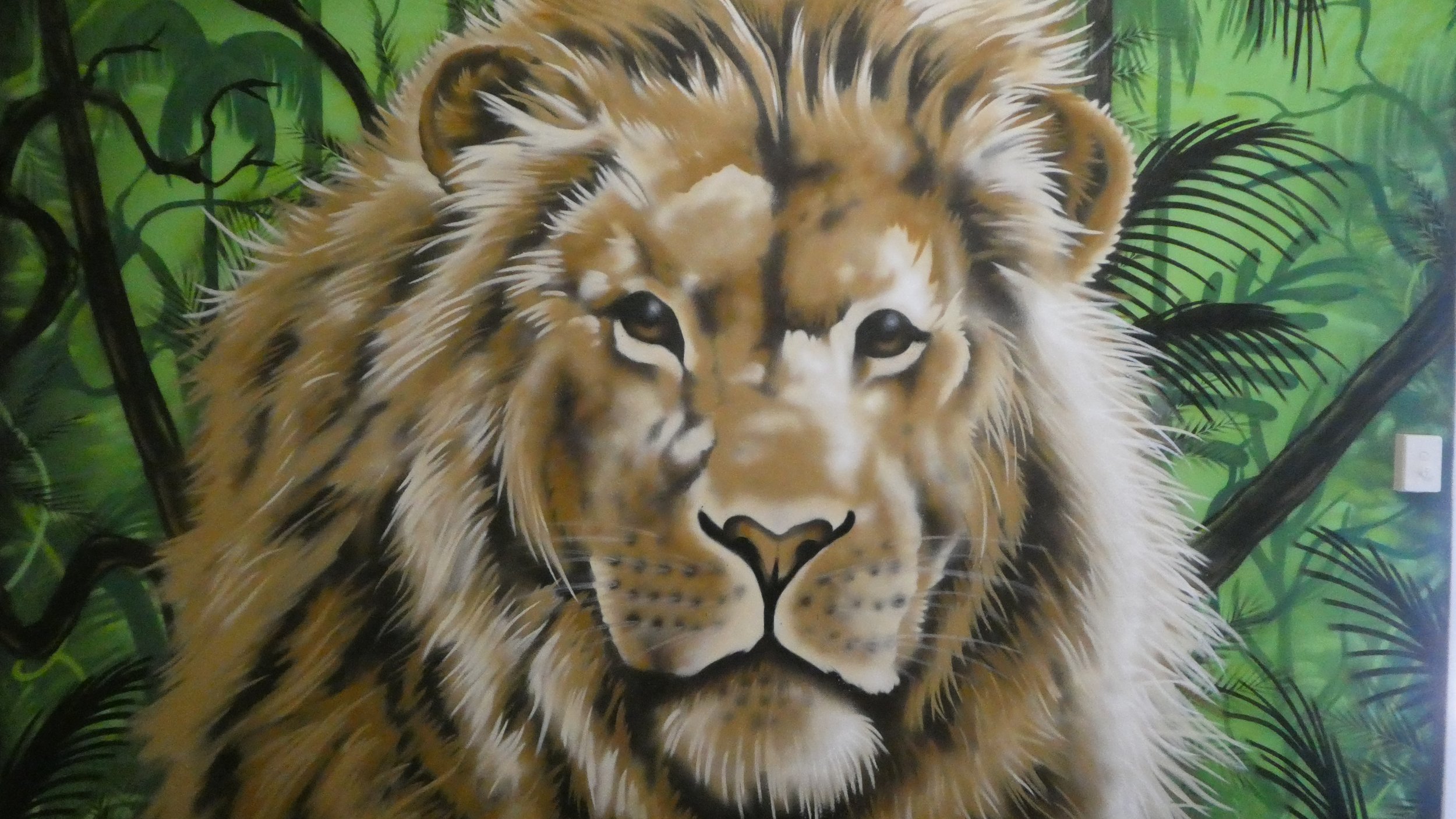 Painting of a lion with a lush green jungle background.