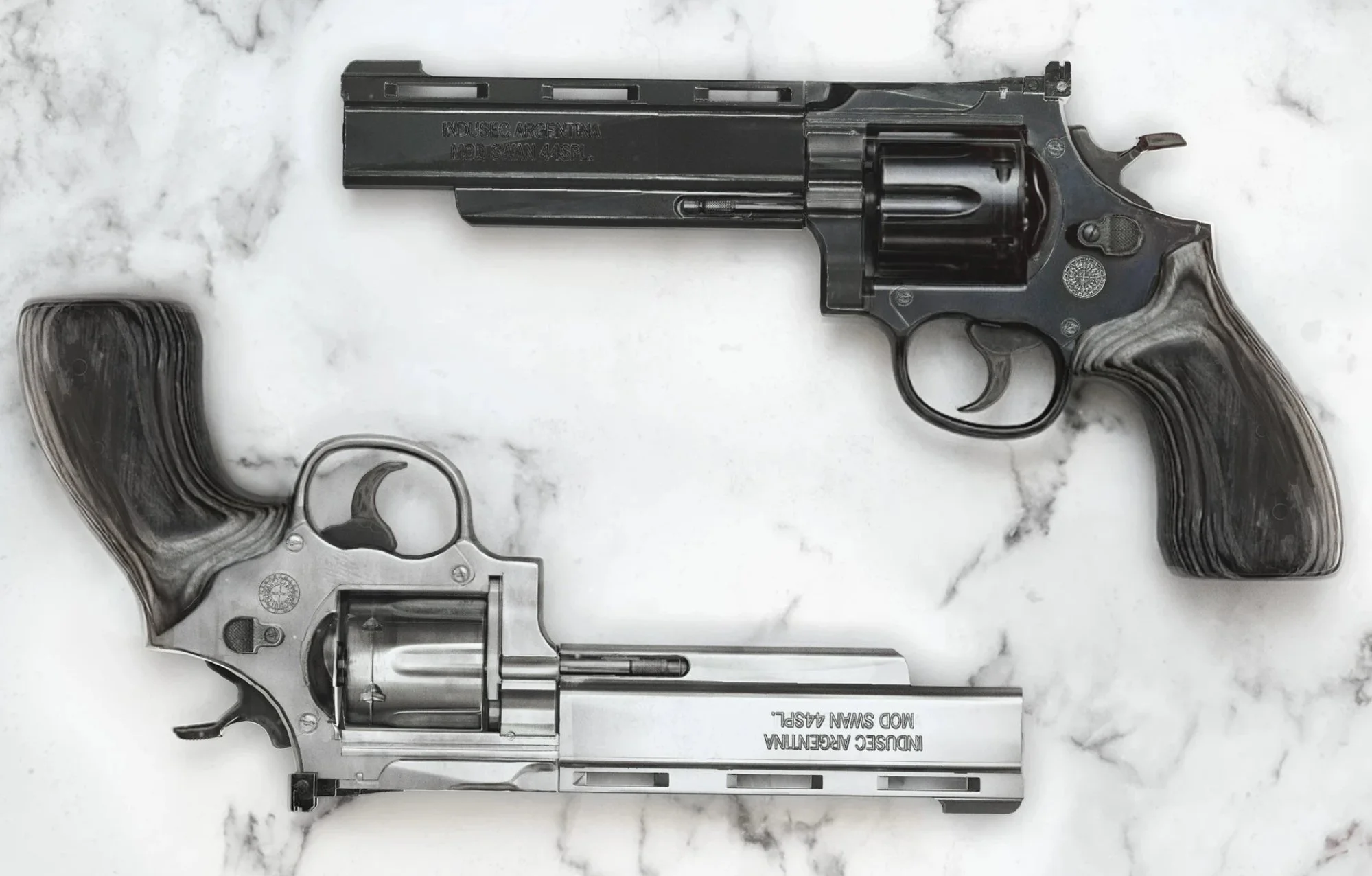 Two revolvers on a marble surface, one black and one silver, both with wooden grips.