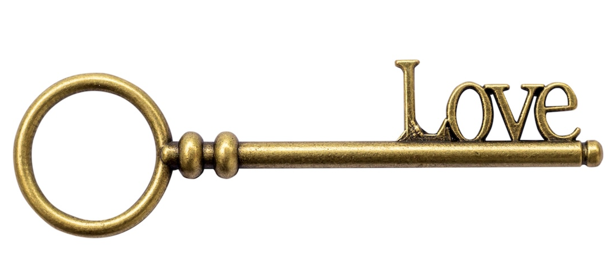 A golden key in the shape of the word LOVE representing the power of lock to unlock the heart