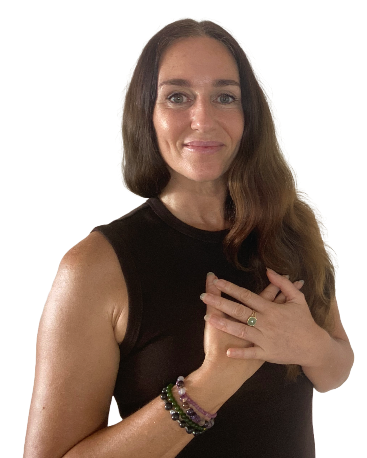 Tara Love Perry - founder of Transformational Self-Love Therapy™ wearing a black sleeveless top, has her hands placed on her chest. She is smiling softly and wearing jewelry on her wrists and fingers.