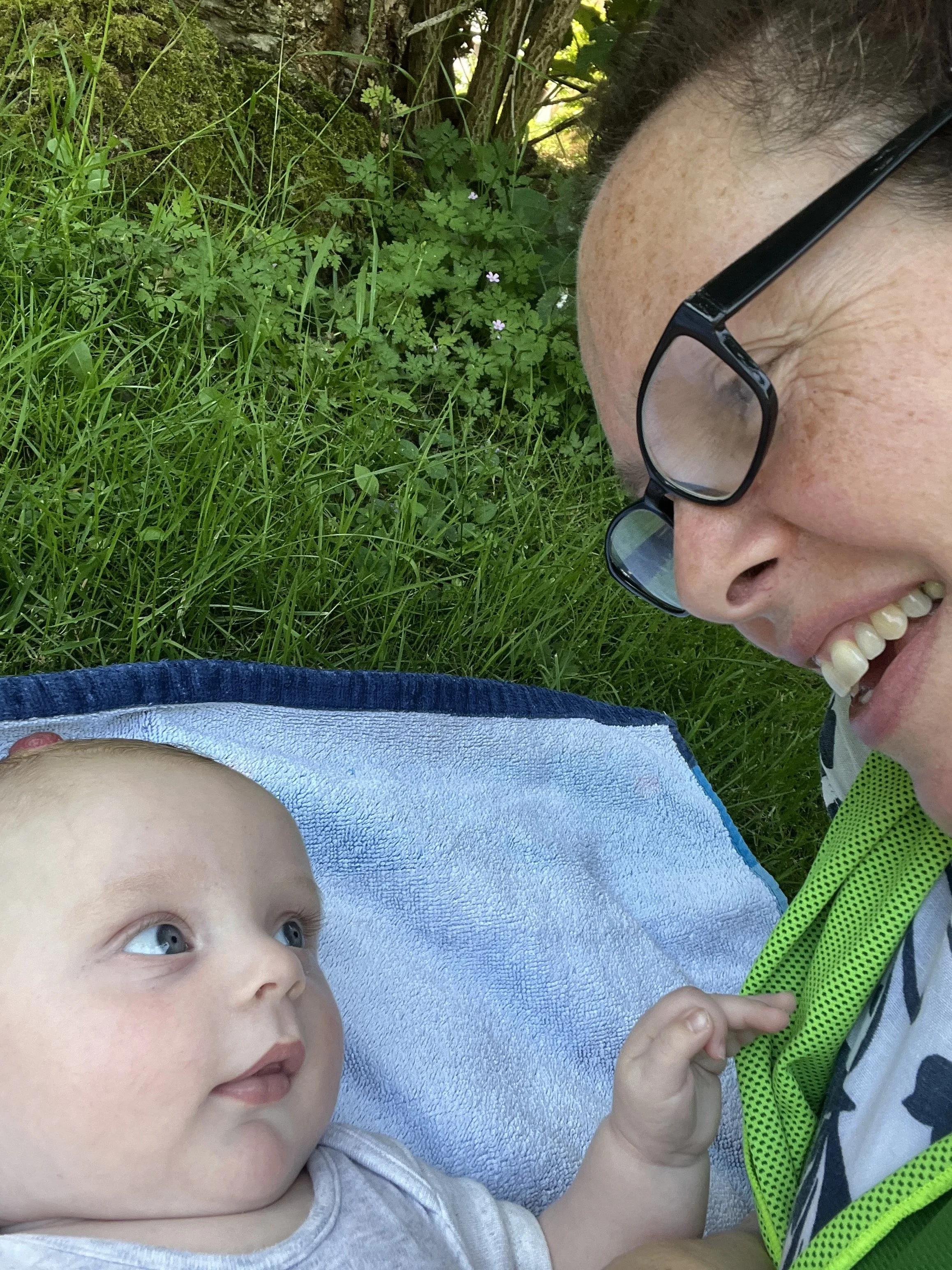 Zoe Sylvester smiling and engaging with a baby, reflecting the warm, relationship-based approach at the heart of her doula support.
