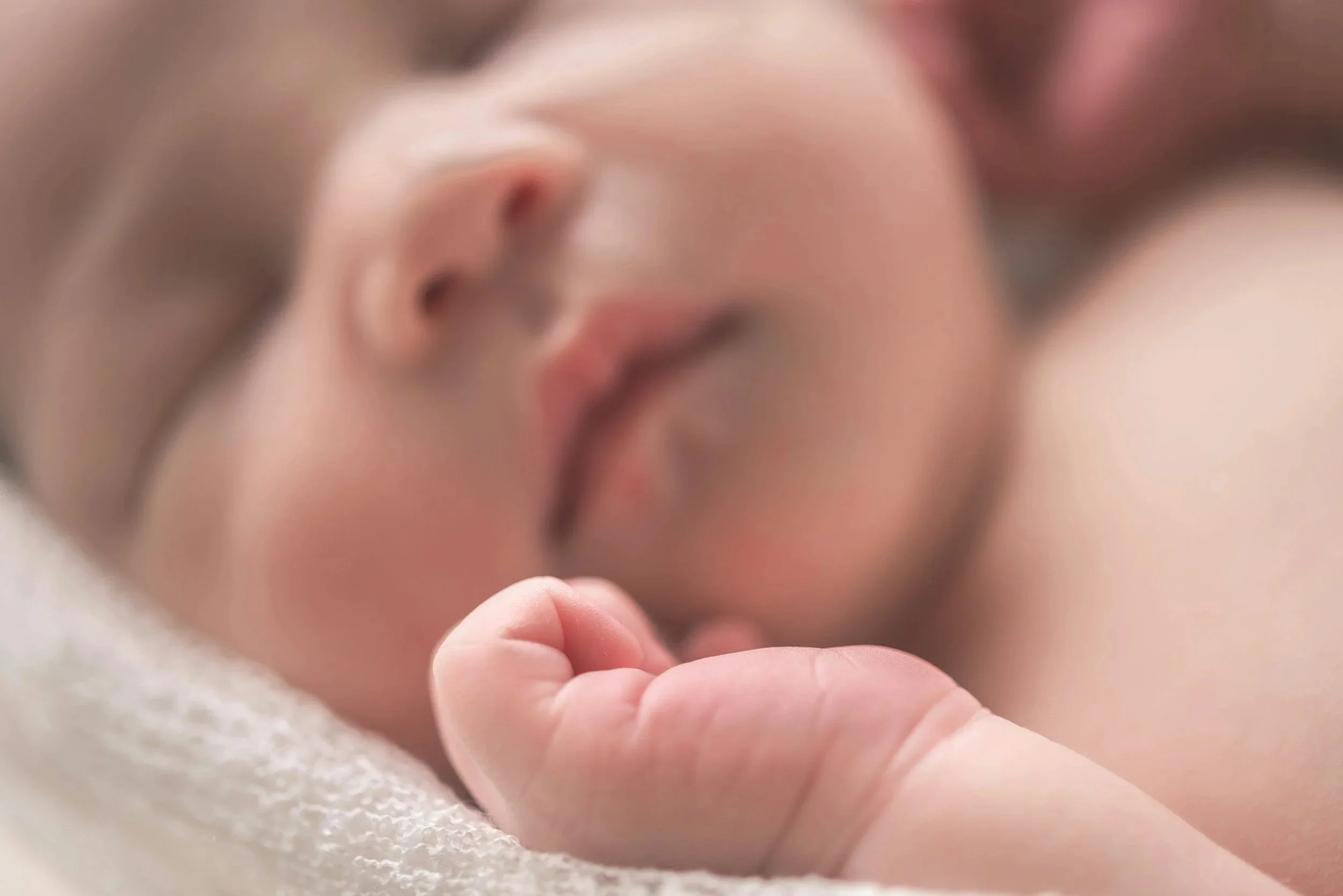 Peacefully sleeping newborn baby after birth, representing the support available to first-time parents.
