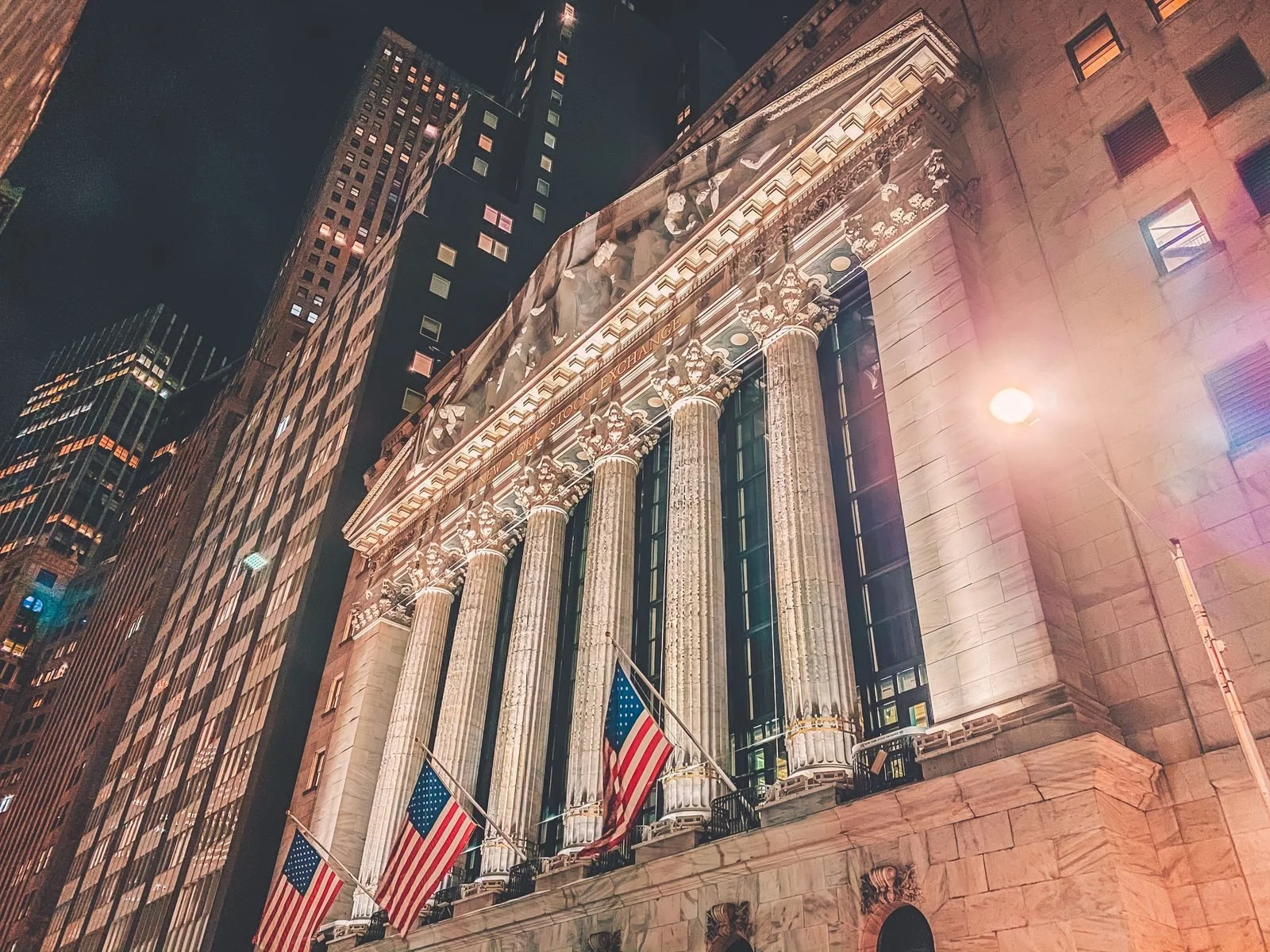 New York Stock Exchange building lit up at night, symbolizing US stock market history and the lost decade of 2000-2009.