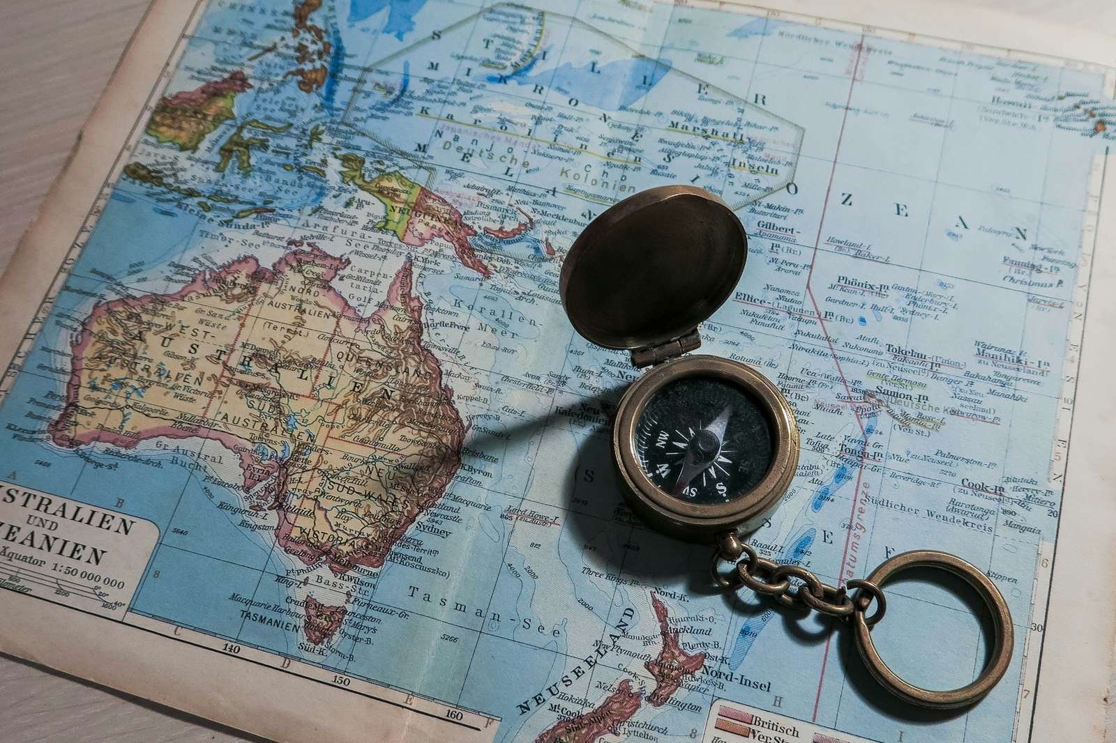 Compass on world map symbolizing choosing a retirement destination through geographic arbitrage.