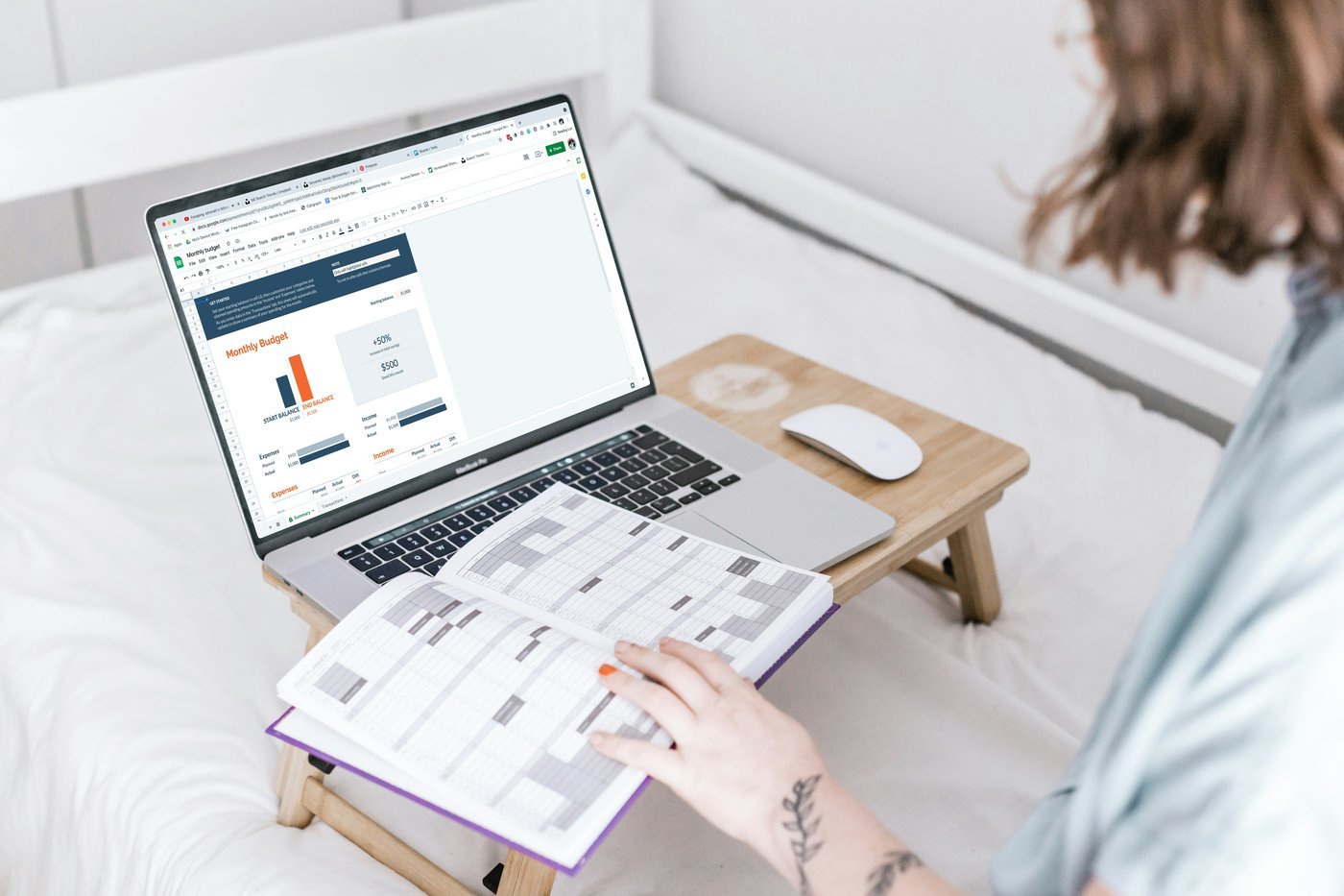 Woman reviewing financial spreadsheet on laptop with planner open — representing the periodic portfolio review process for rebalancing.