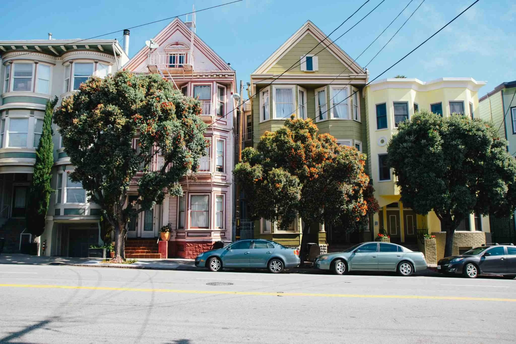 Colorful houses in San Francisco illustrating urban housing costs and declining affordability for younger generations.